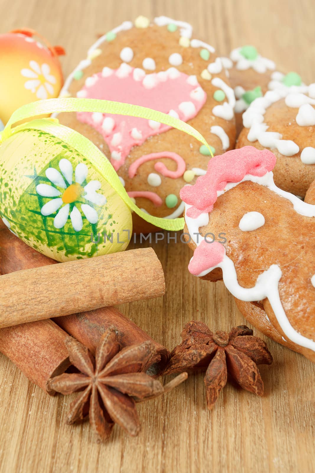 Easter gingerbreads and painted egg on wooden background