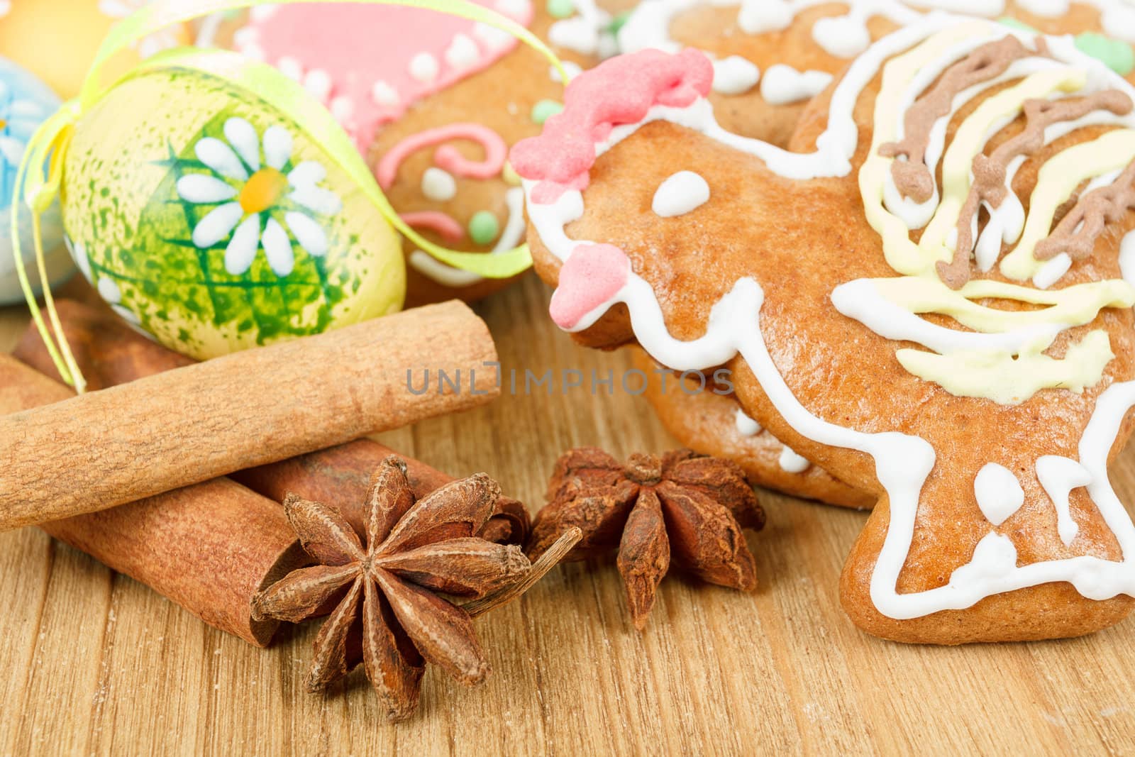 Easter gingerbreads and painted egg on wooden background