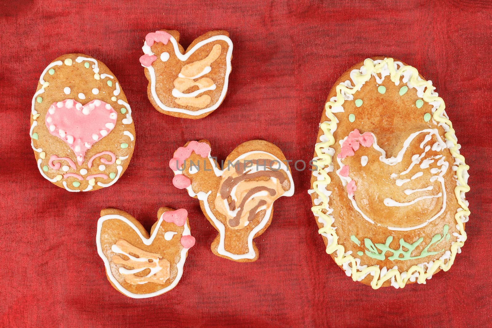 Easter gingerbreads rooster and hen on red background