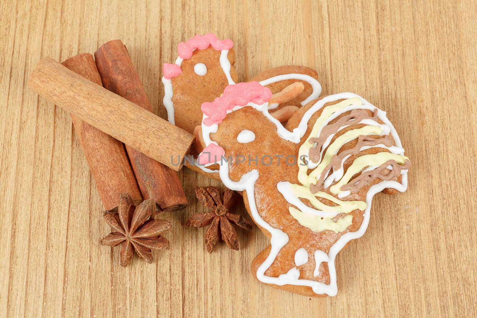 Easter gingerbreads and cinamon on wooden background