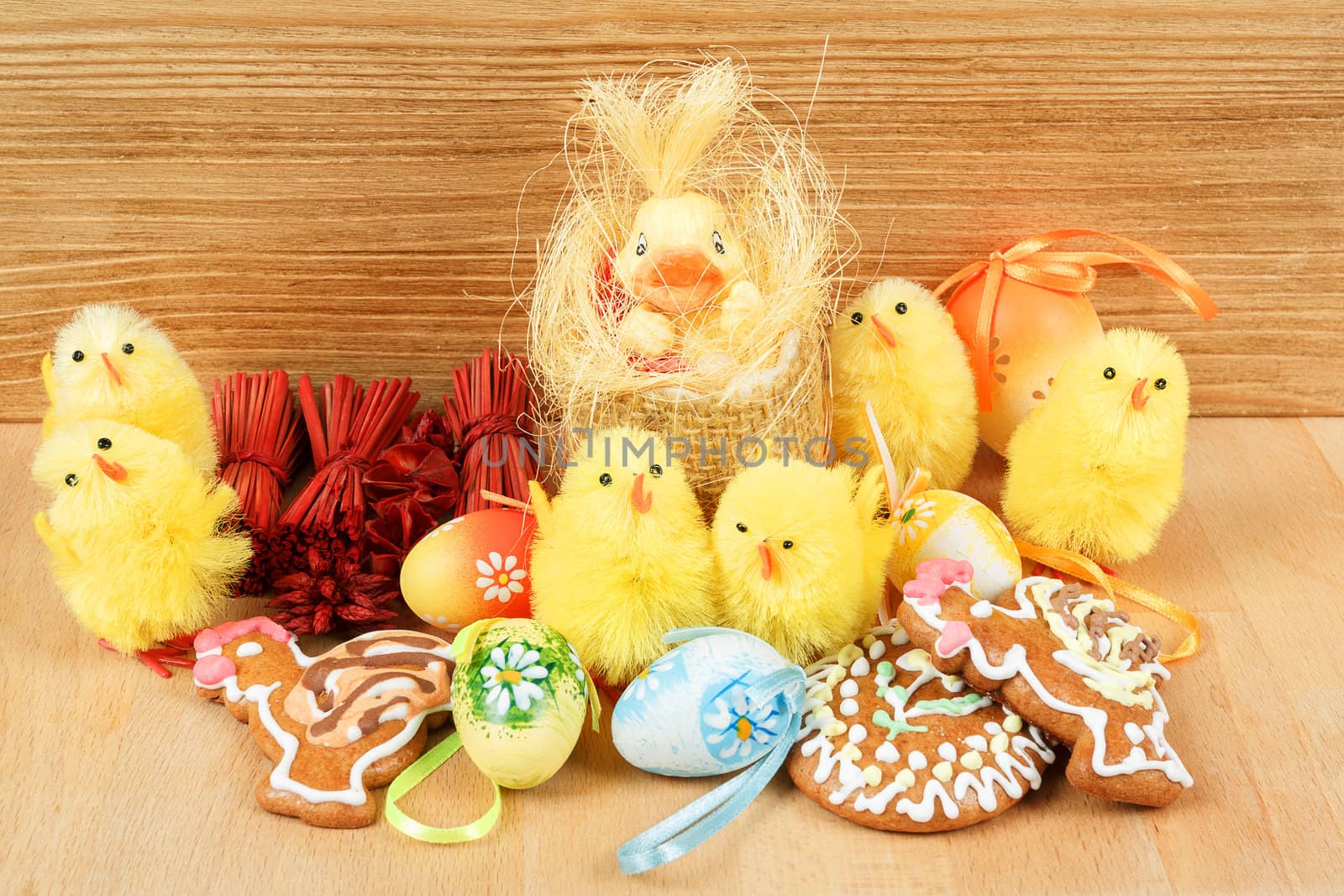 easter decoration, gingerbread, chicken and painted eggs wooden background