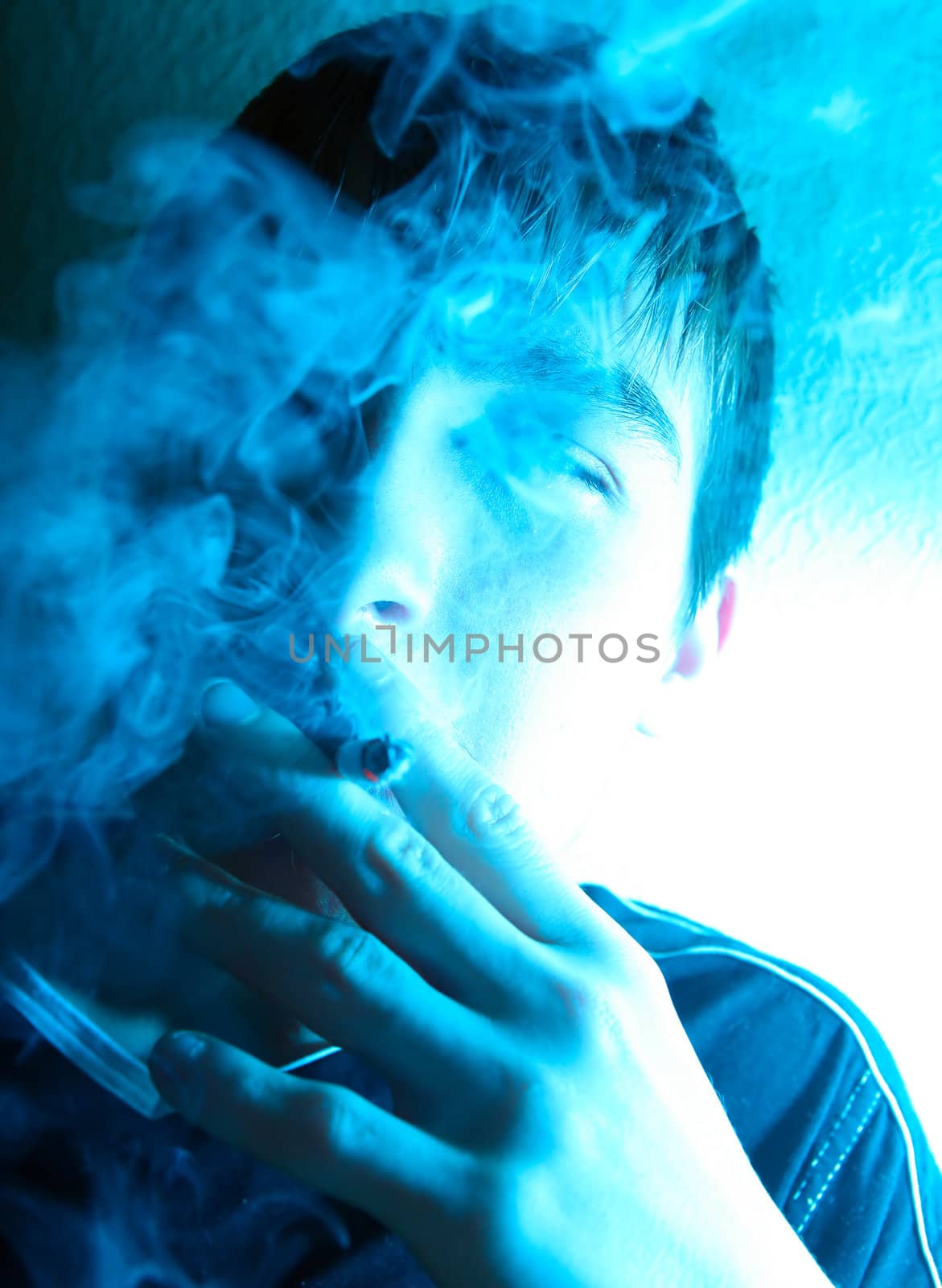 Portrait of Smoking Young Man in the Deep Blue light