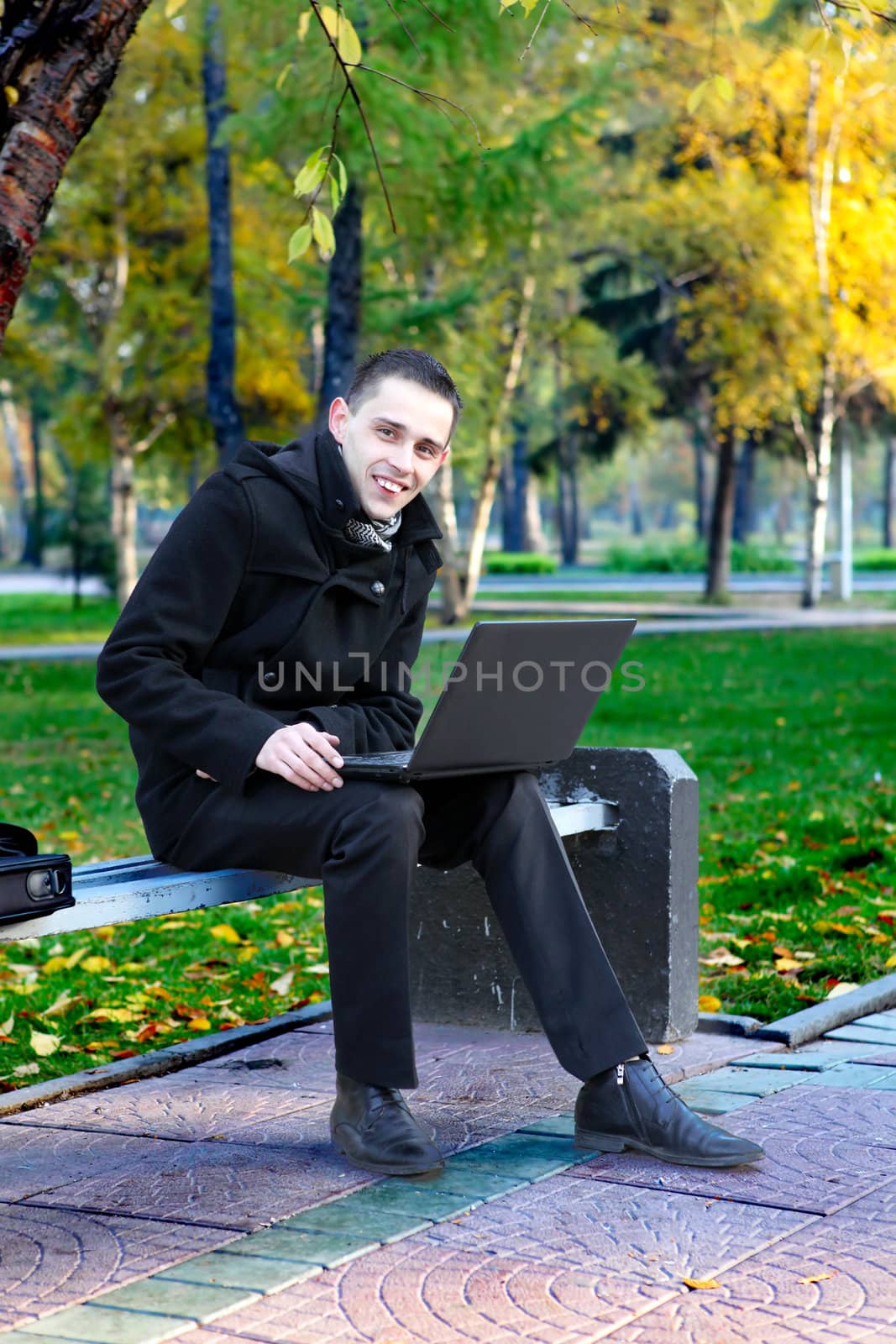 Man With Laptop Outdoor by sabphoto