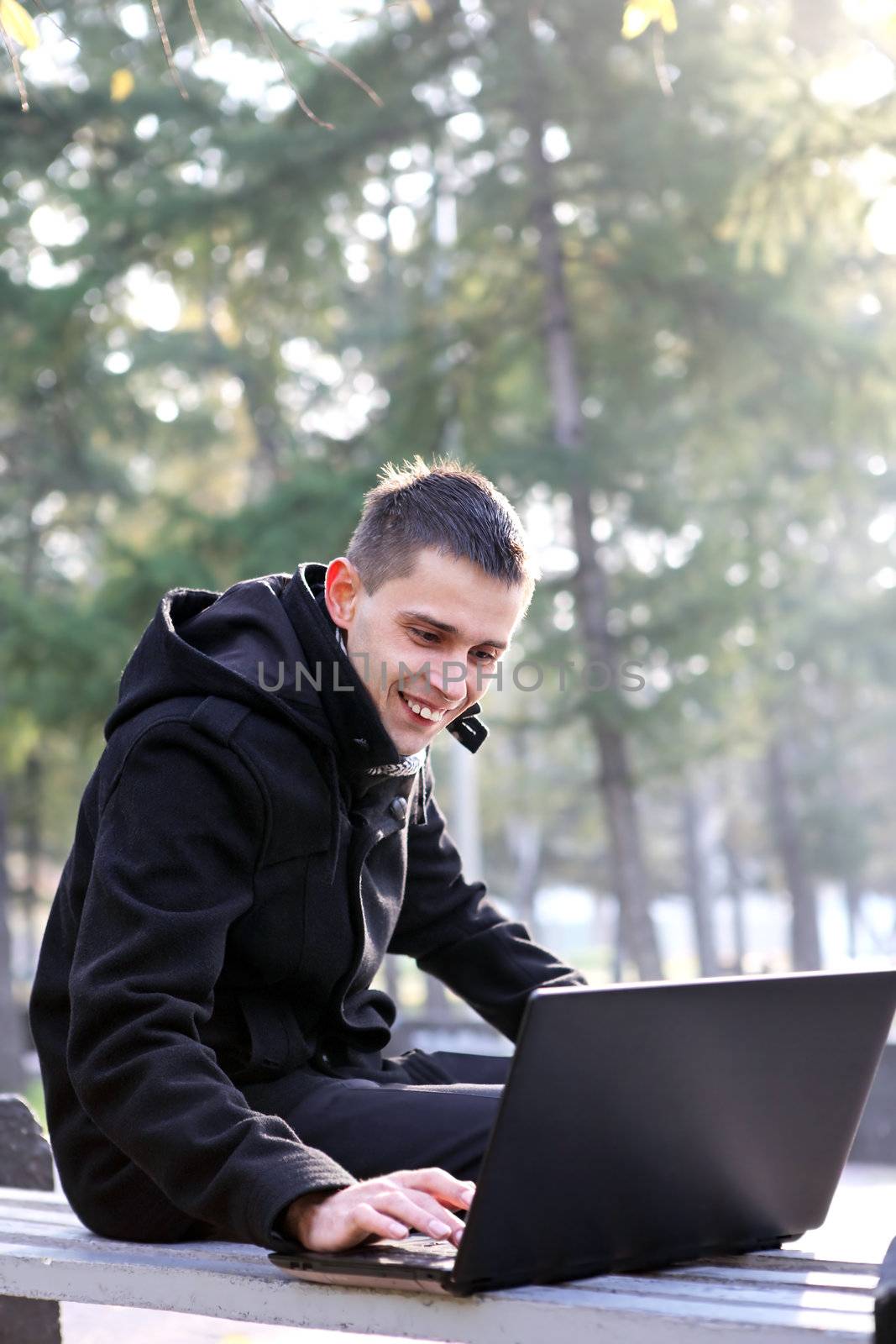 Man With Laptop At The Park by sabphoto