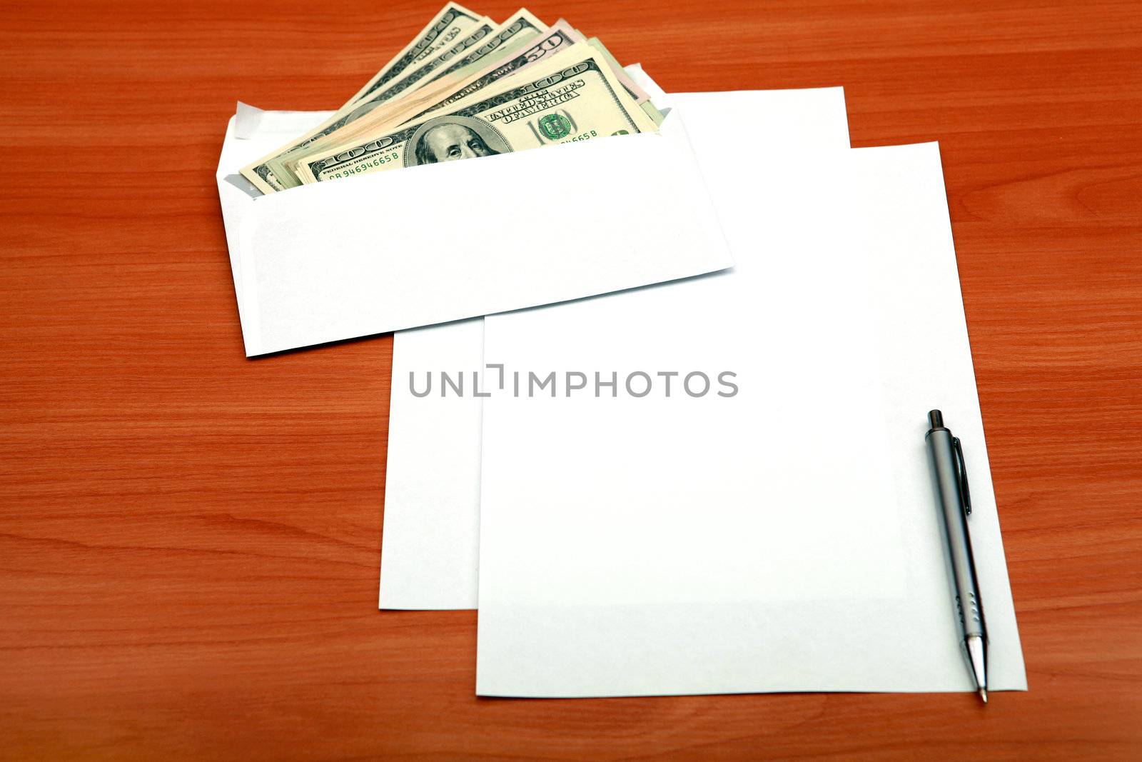 Envelope with a Money and Empty Paper for Text on the Wooden Table