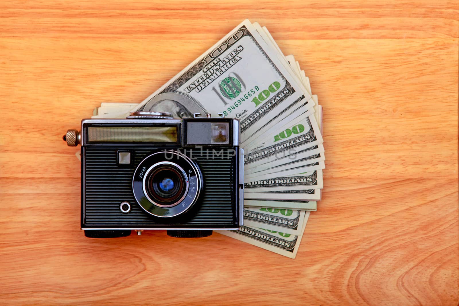 Vintage Camera And Money on the Wooden Background