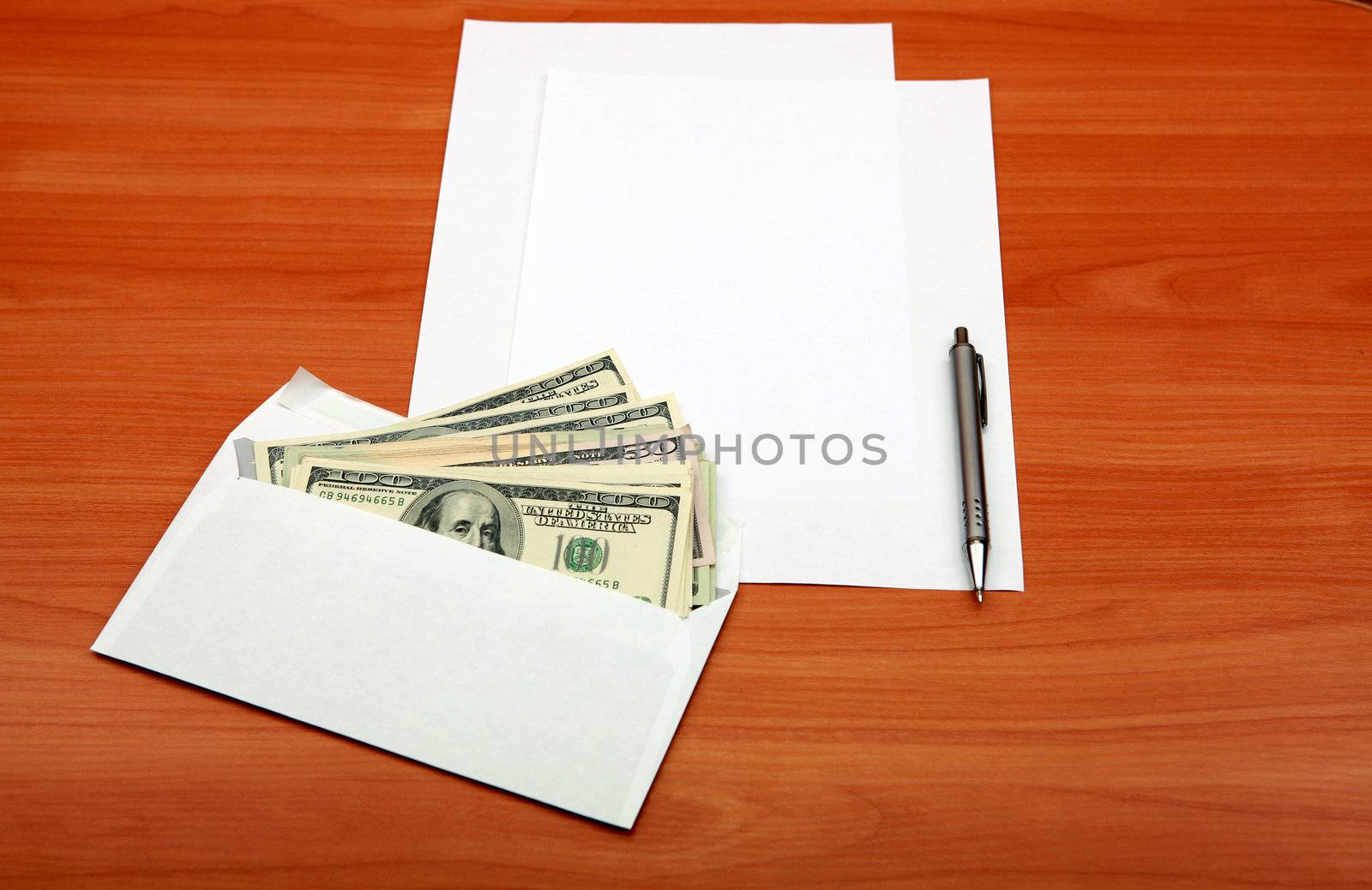 Envelope with a Money and Empty Paper for Text on the Wooden Table