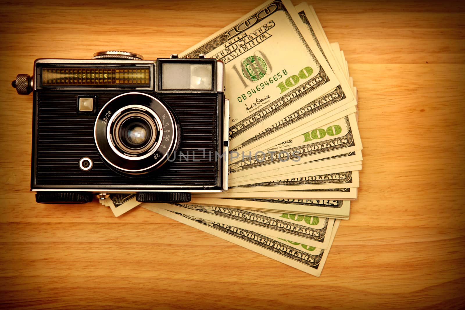 Vintage Camera And Money on the Wooden Background