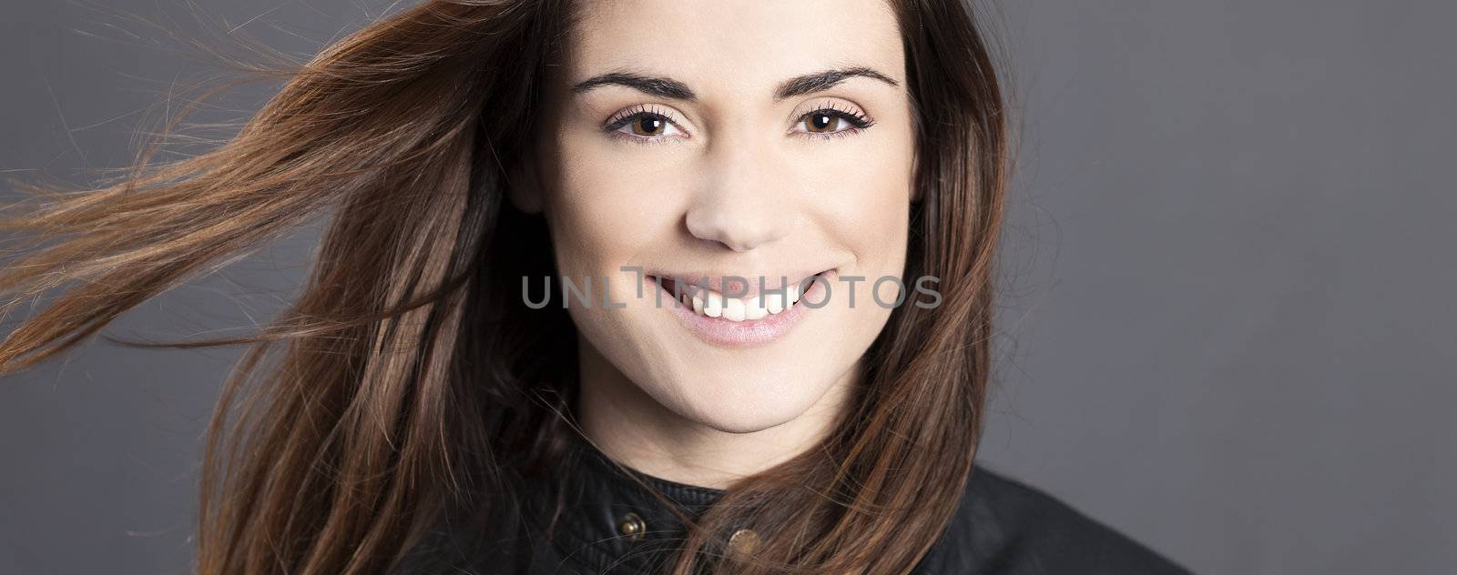 Panoramic portrait of beautiful woman model with hair in the wind