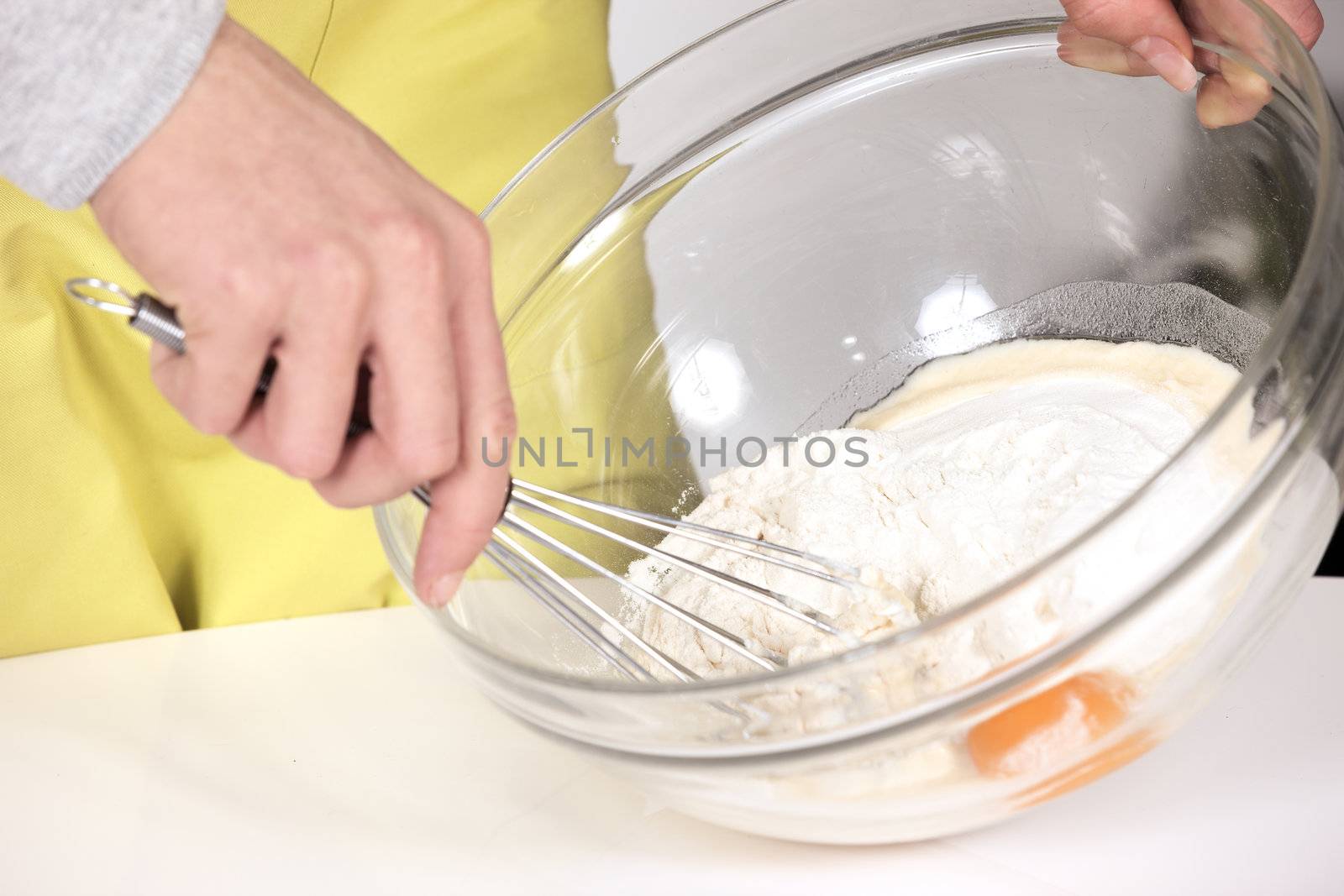 woman whisking batter in kitchen