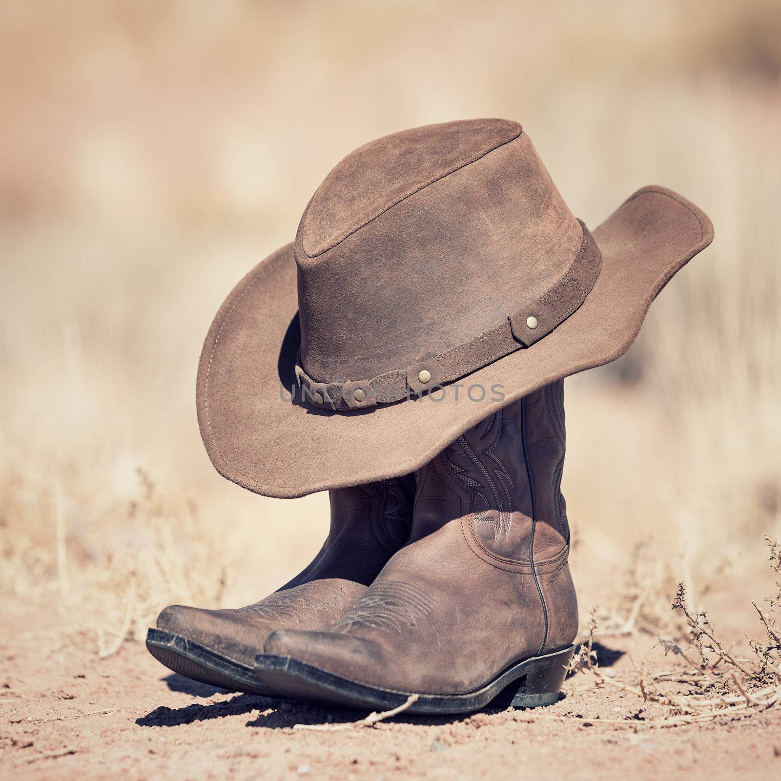 brown cowboy hat and boots outdoor