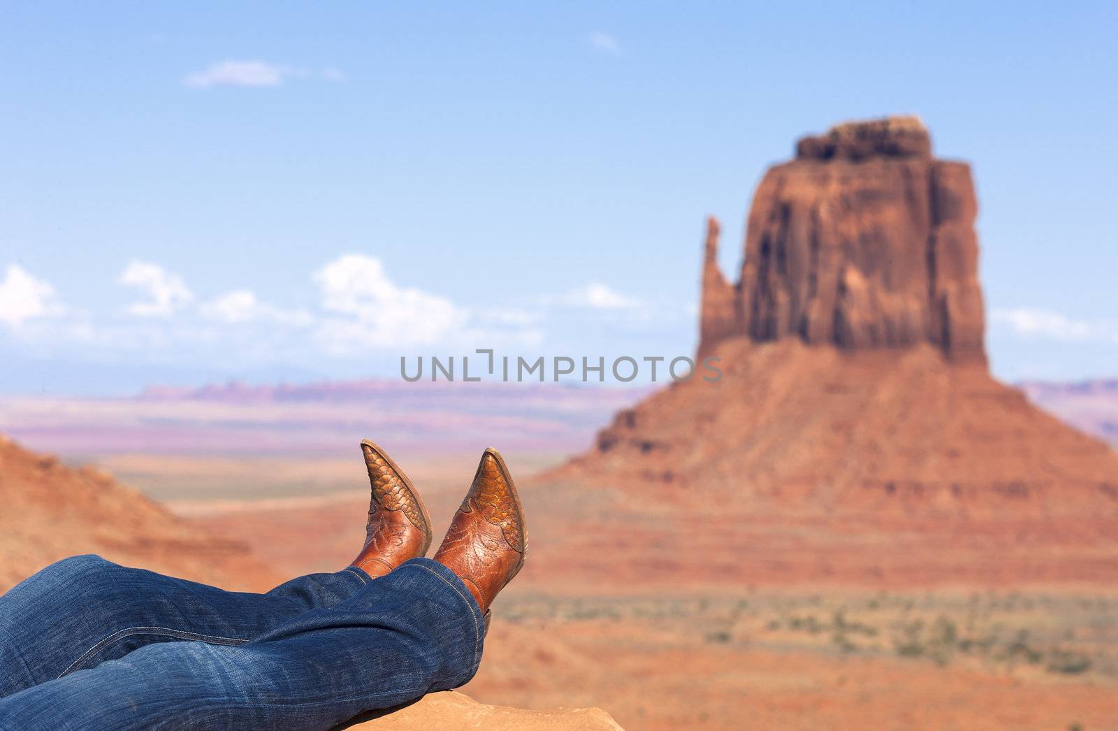 cowgirl's legs in jeans and boots at Monument Valley