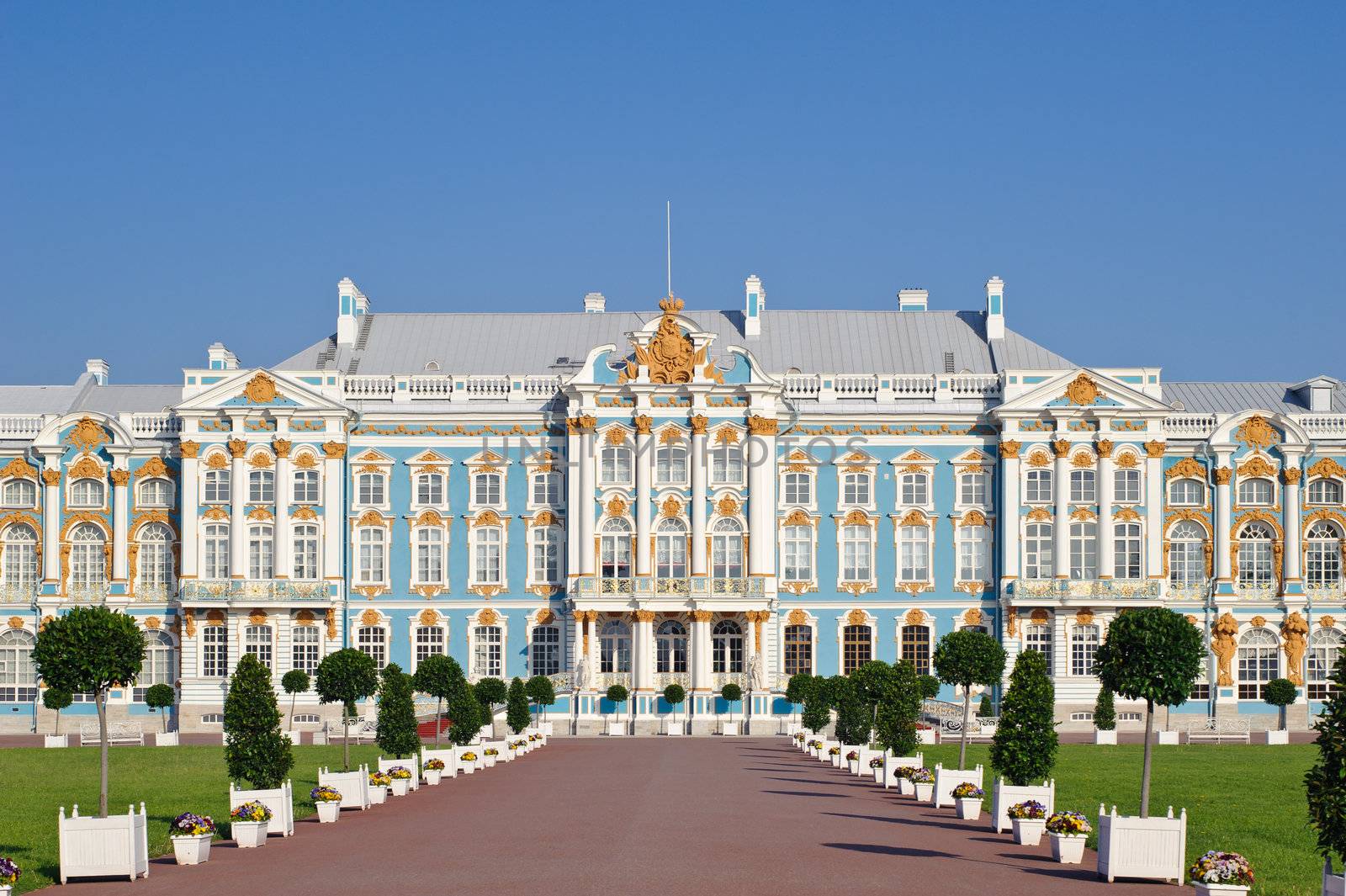 Main facade of the historic palace in the Baroque style. Blue, white and gold gamma. Summer sunny day.