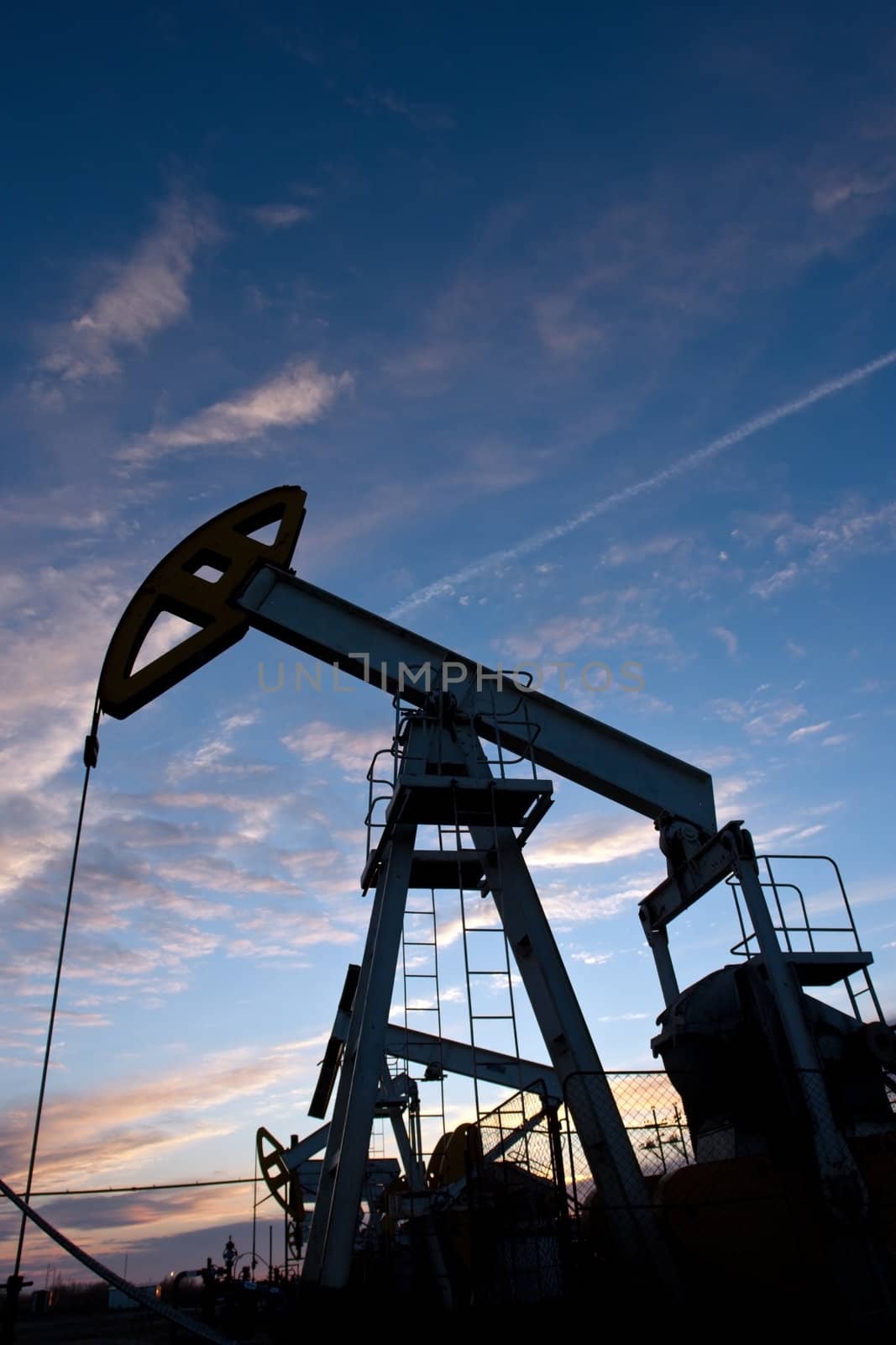 The oil pump on a background of the sunset sky 