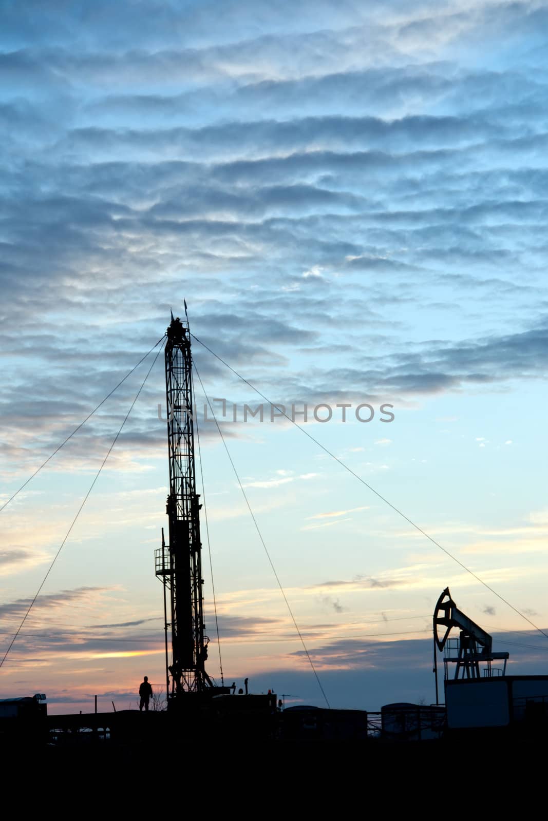 Drilling Rig at sunset sky background. Oil fields in Western Siberia