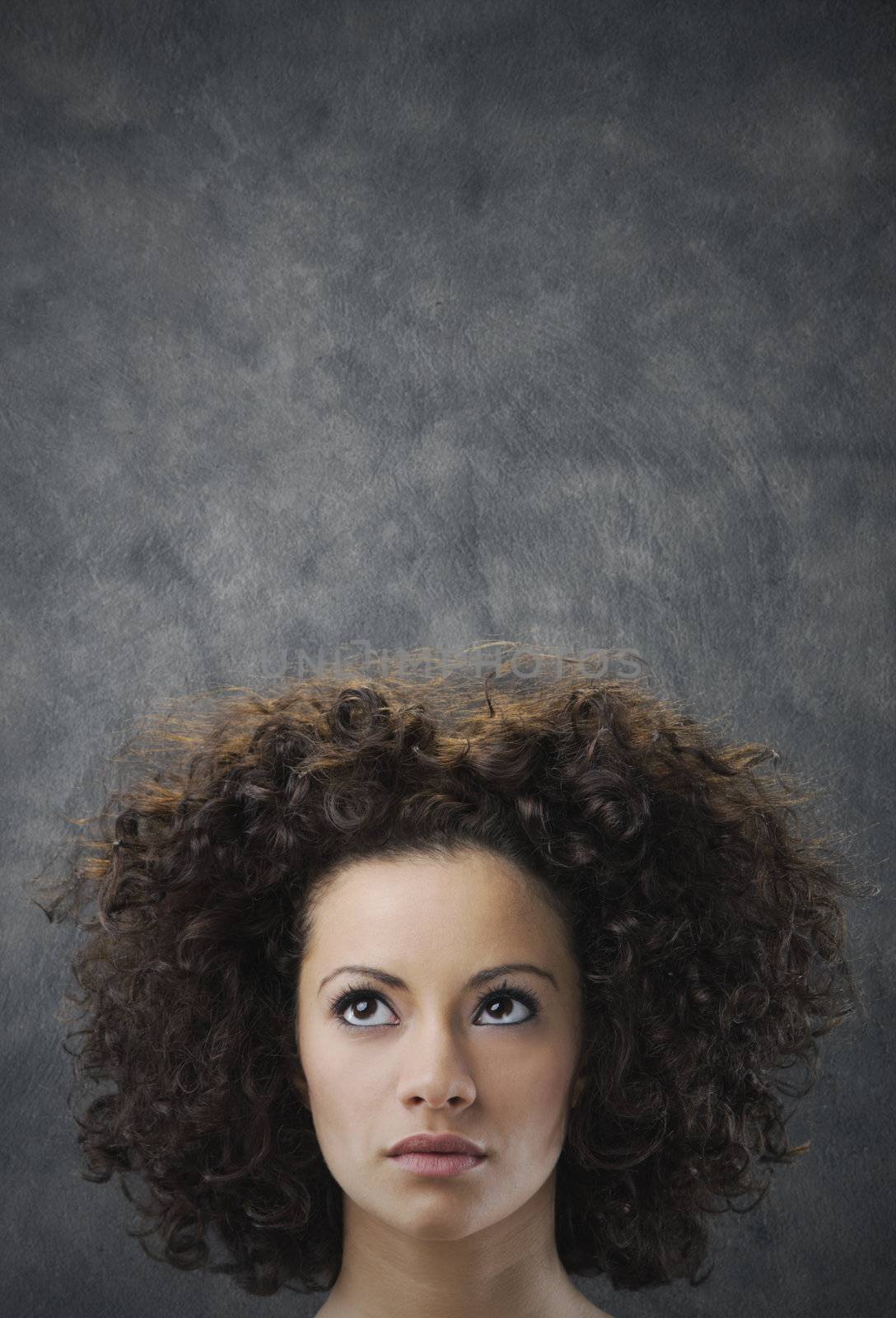 Portrait of young beautiful woman looking up