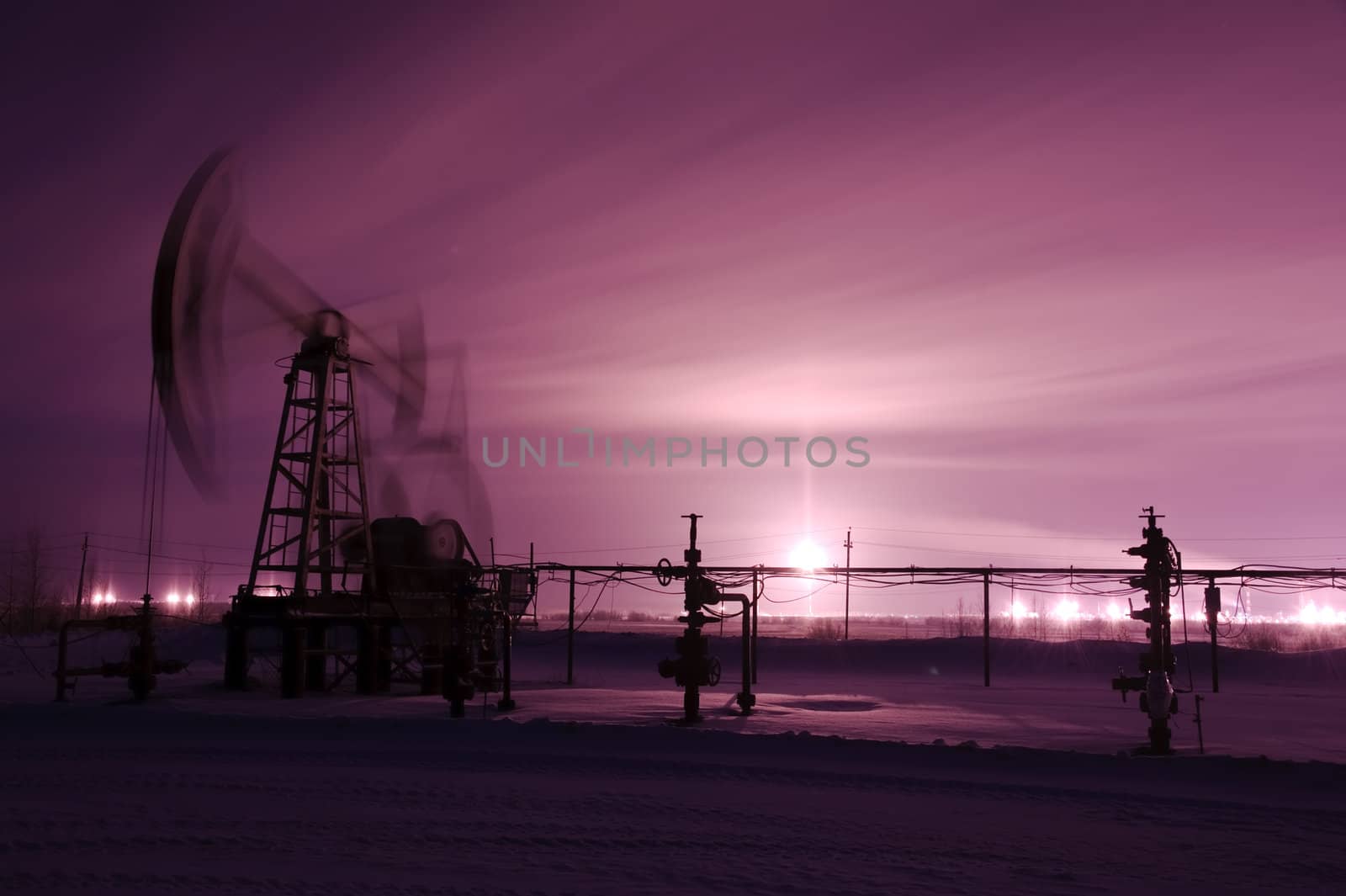 Oil and gas industry. Pump jack. Monochrome. Winter night view.