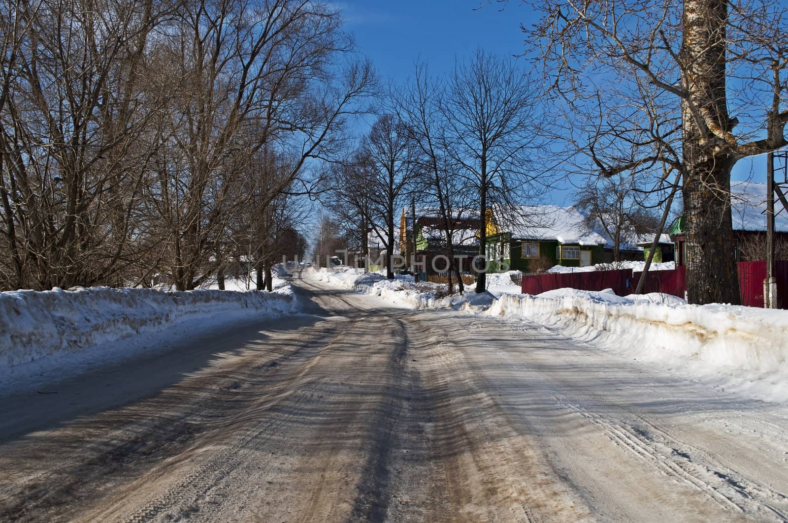 Country road covered with dirty snow