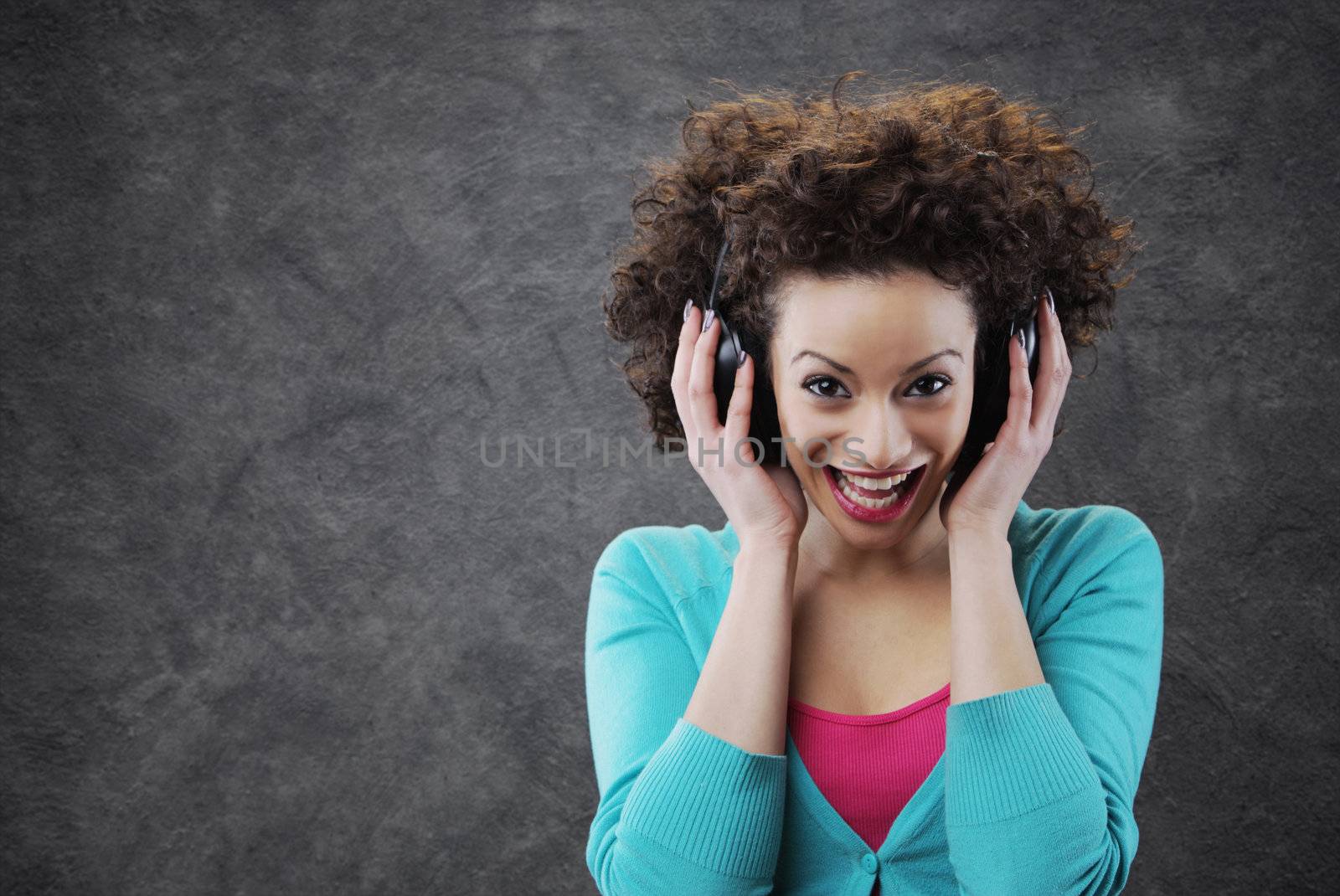 young woman surprised enjoying music