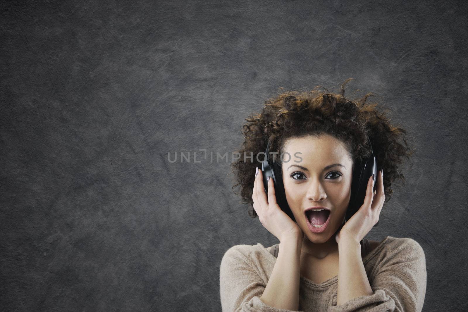 young woman surprised enjoying music