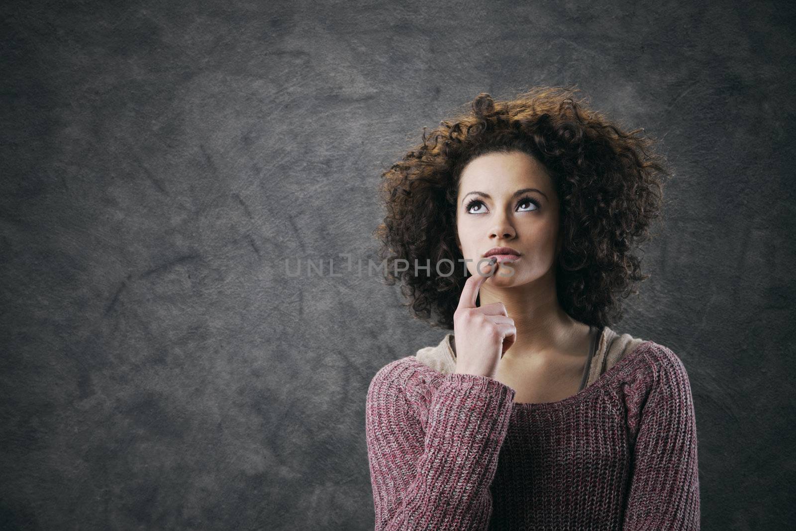 Portrait of young beautiful woman thinking
