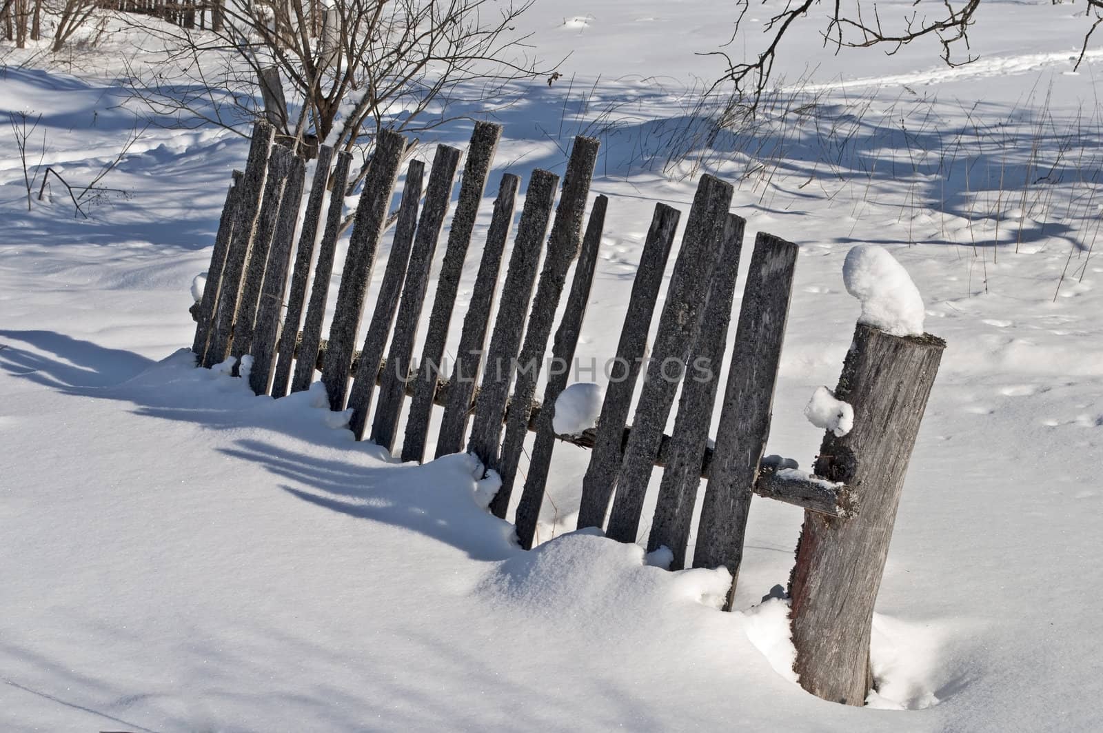  Fragment of old broken wooden fence on the village outskirts