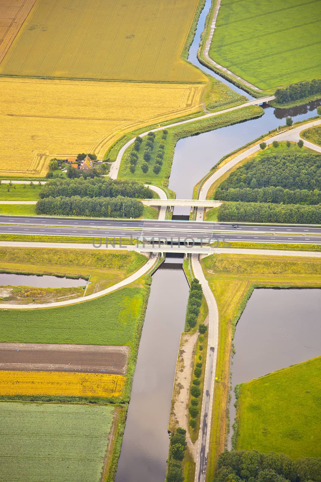 Dutch farm landscape with infrastructure road and canal