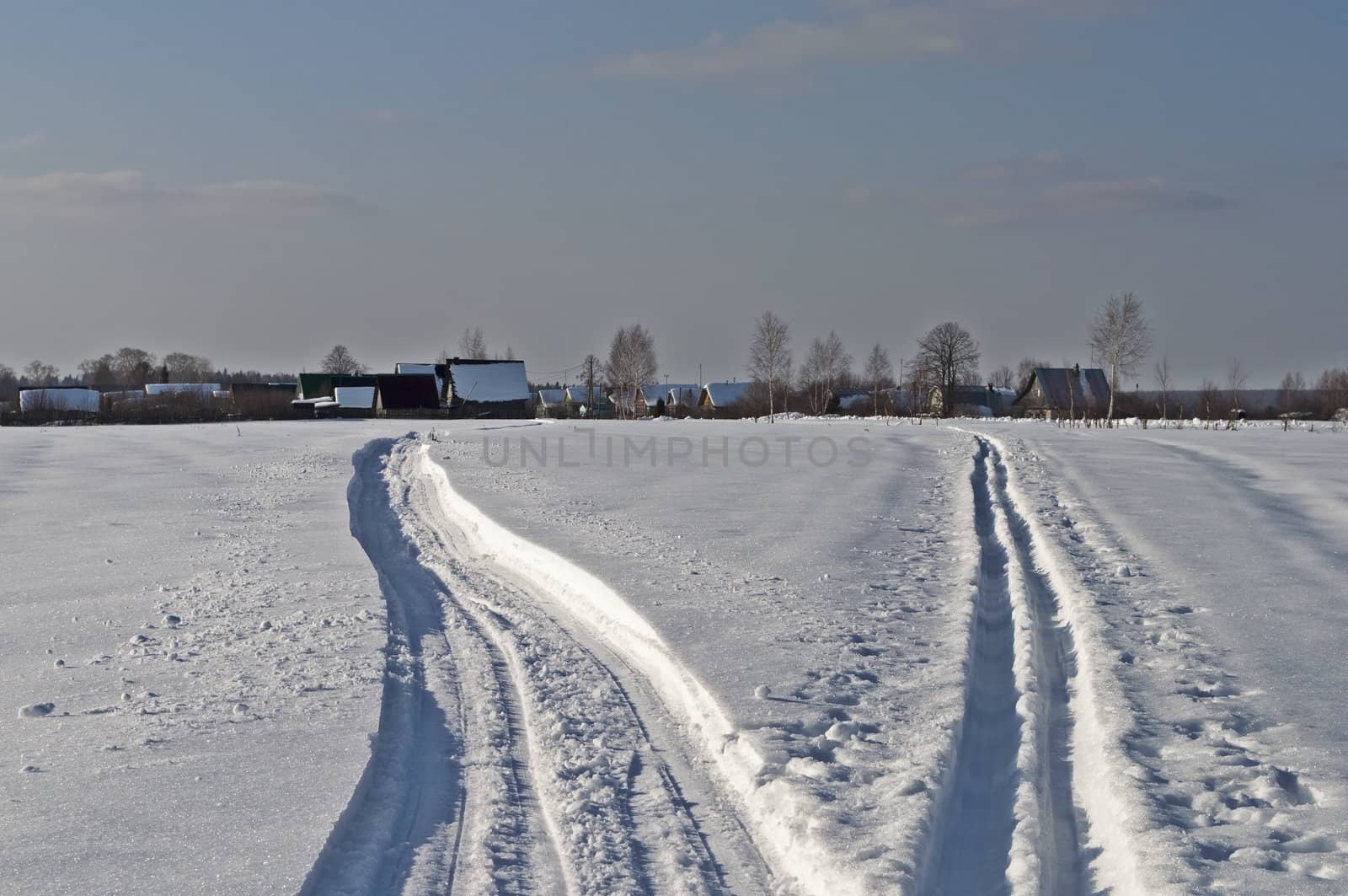 Snowmobile trail and ski track leading to the village