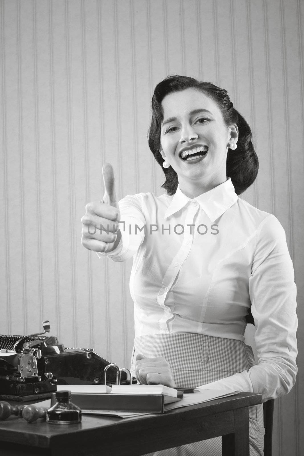 Smiling office worker showing thumb up