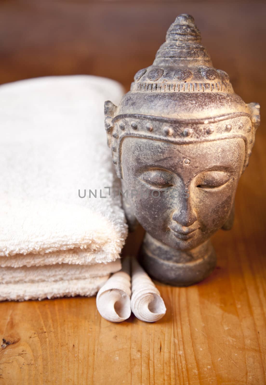 Luxury bath or shower set with towel, buddha and shells on wooden table