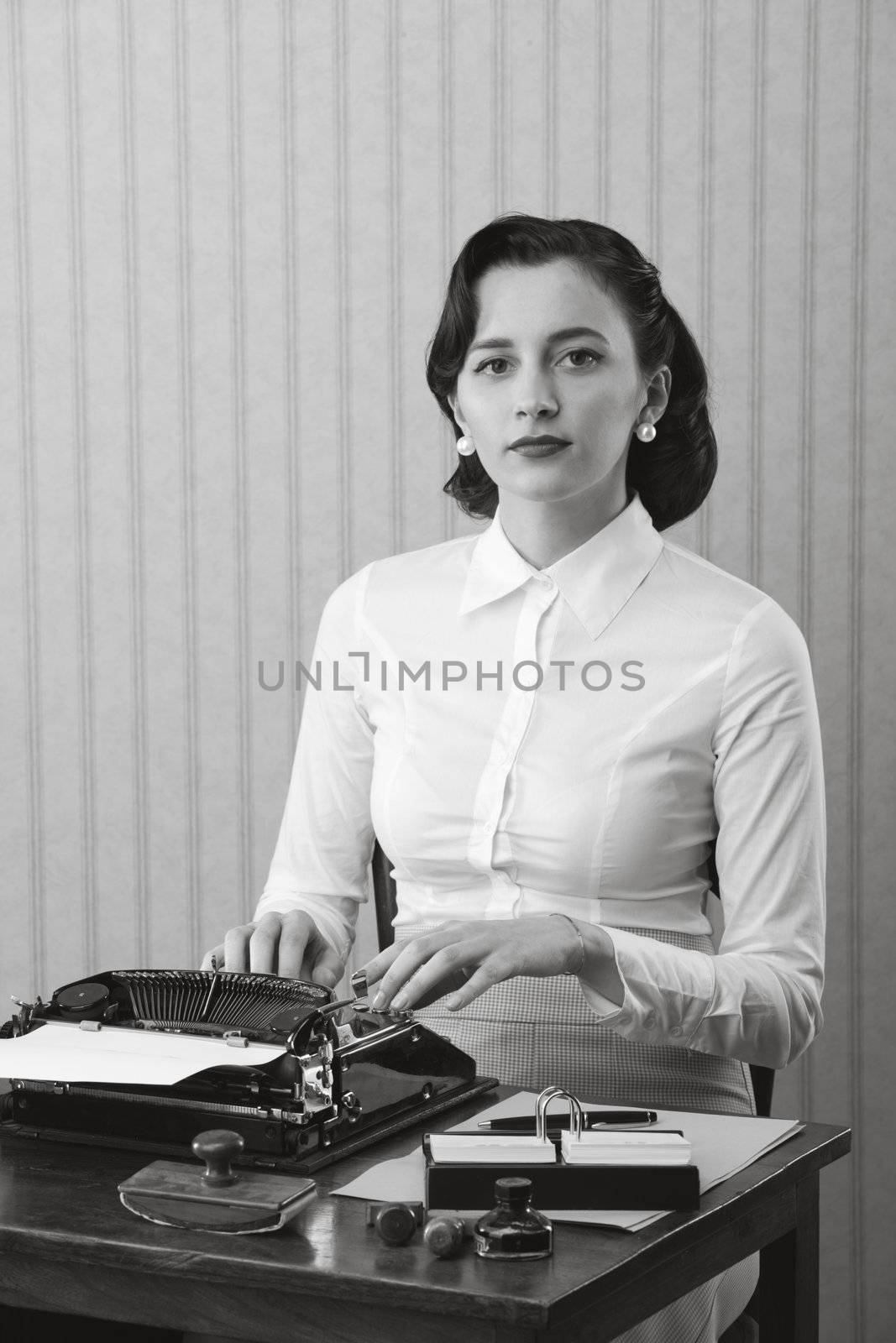 Retro business woman typing in her office