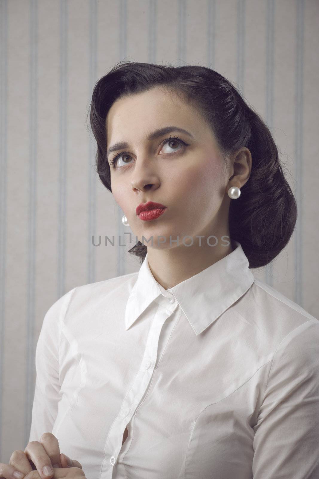 Portrait of beautiful retro business woman looking up