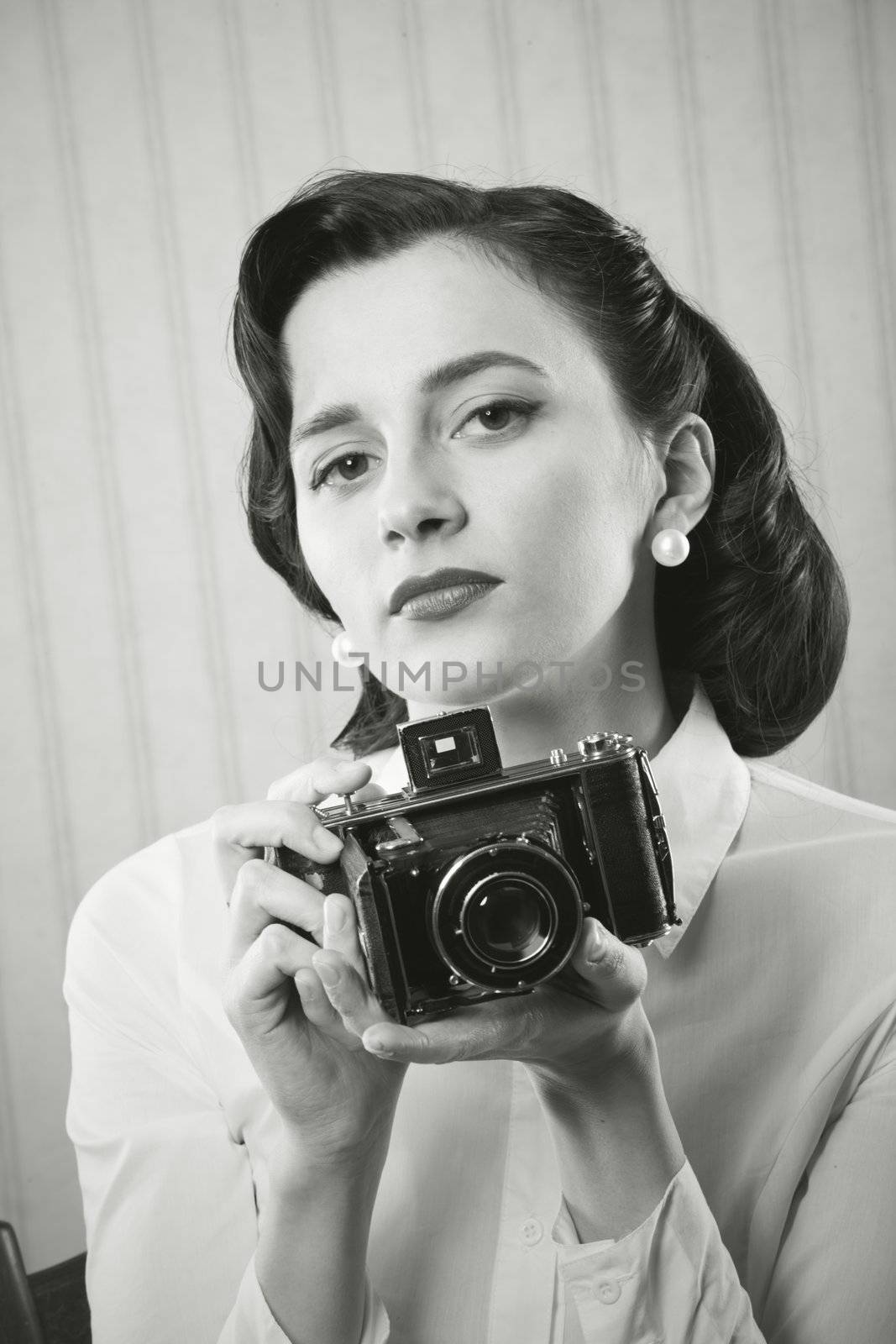 Beautiful business woman with a old camera