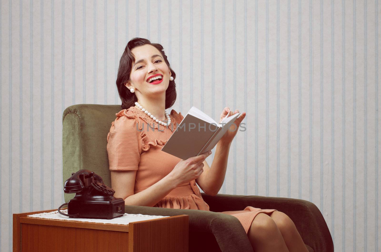 Smiling woman reading book in living room