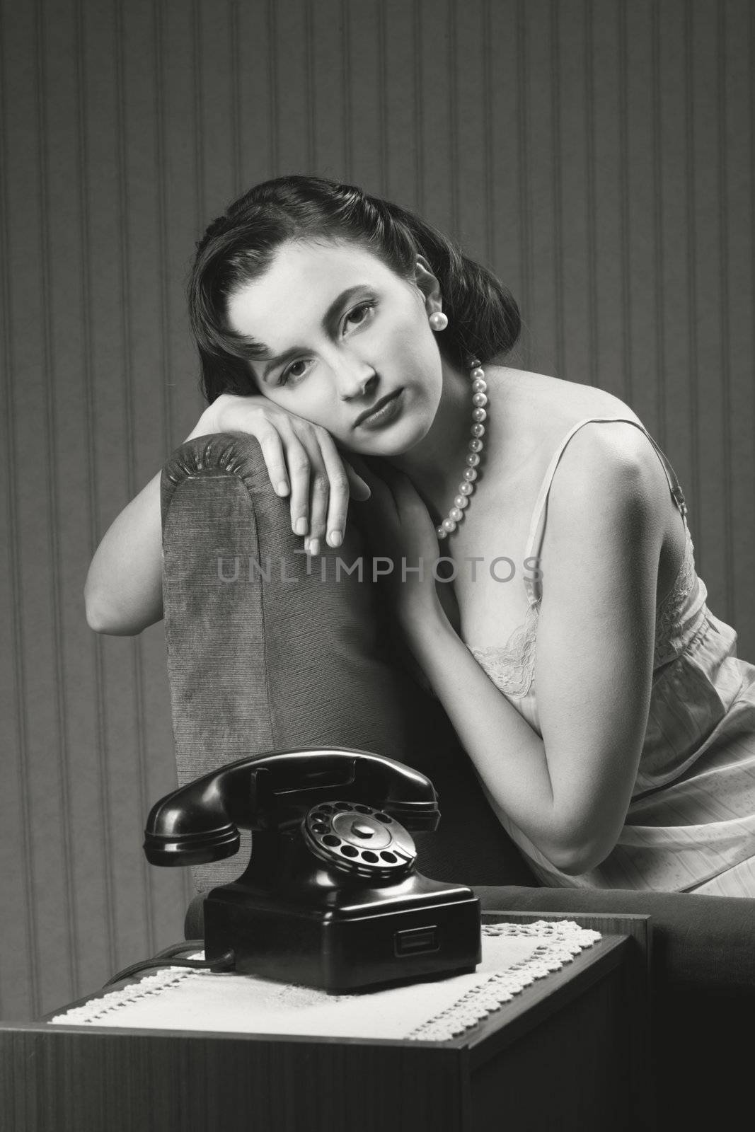 Woman wearing lingeriee waiting for the phone to ring
