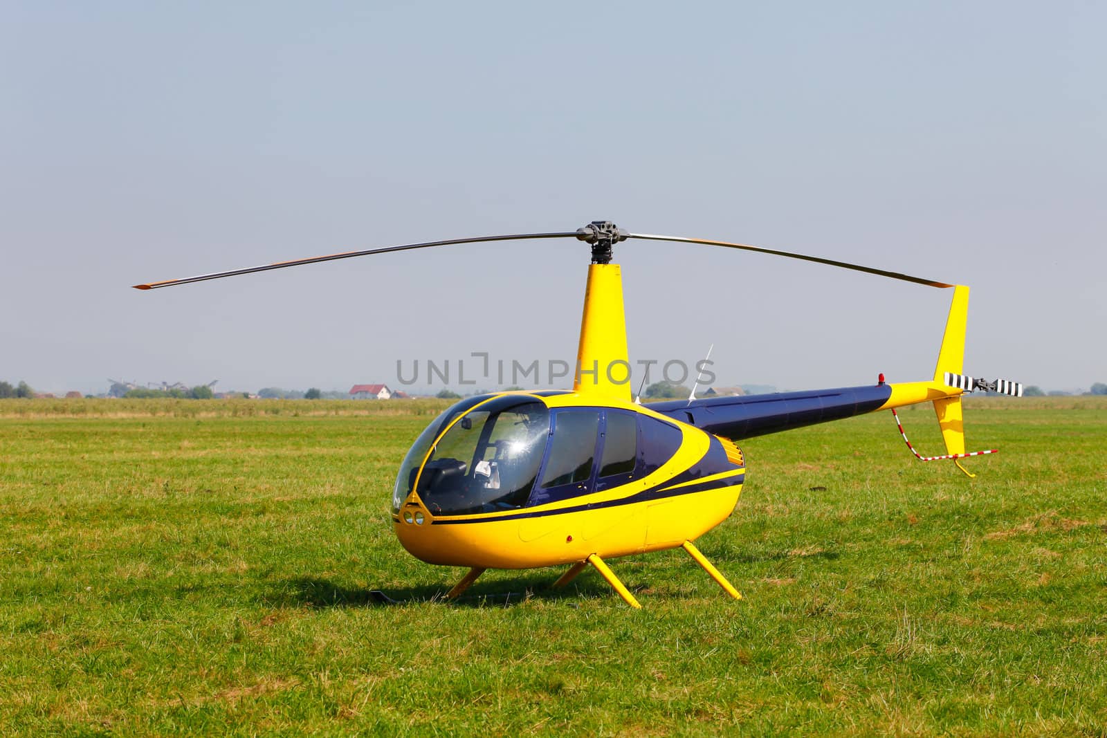 Yellow helicopter on field