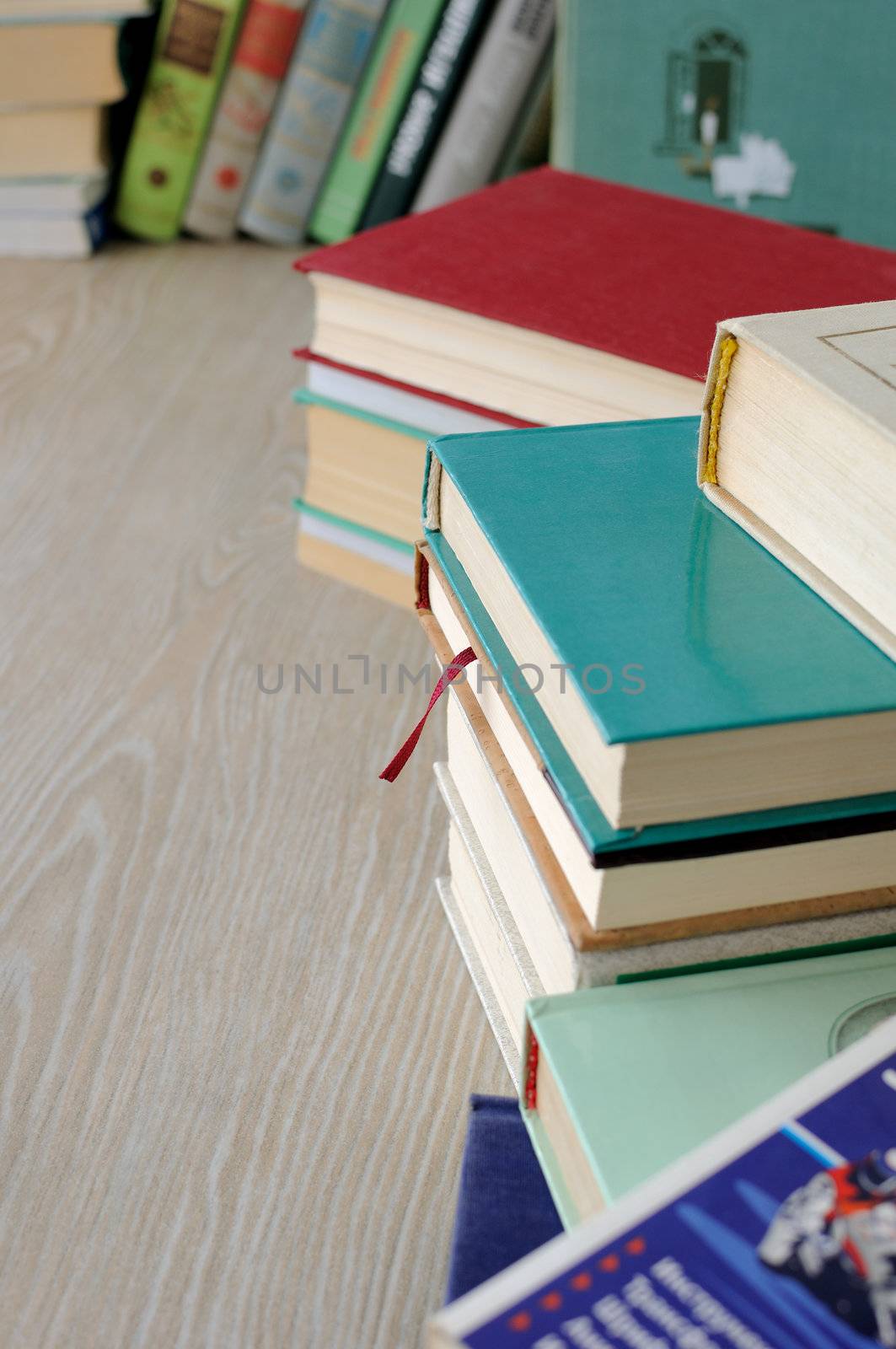 A variety of books in different bindings in stacks on the table