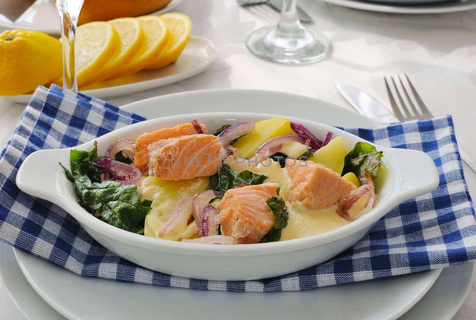 Baked salmon with potatoes and spinach cream sauce