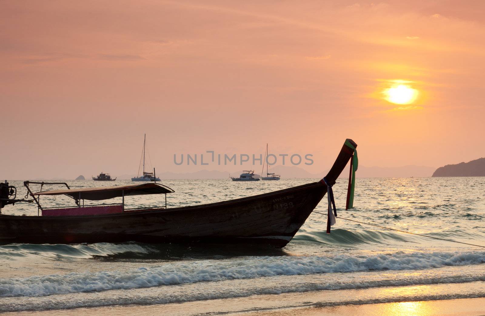 Longtail boats against a sunset. Ao-Nang, Thailand. by elena_shchipkova