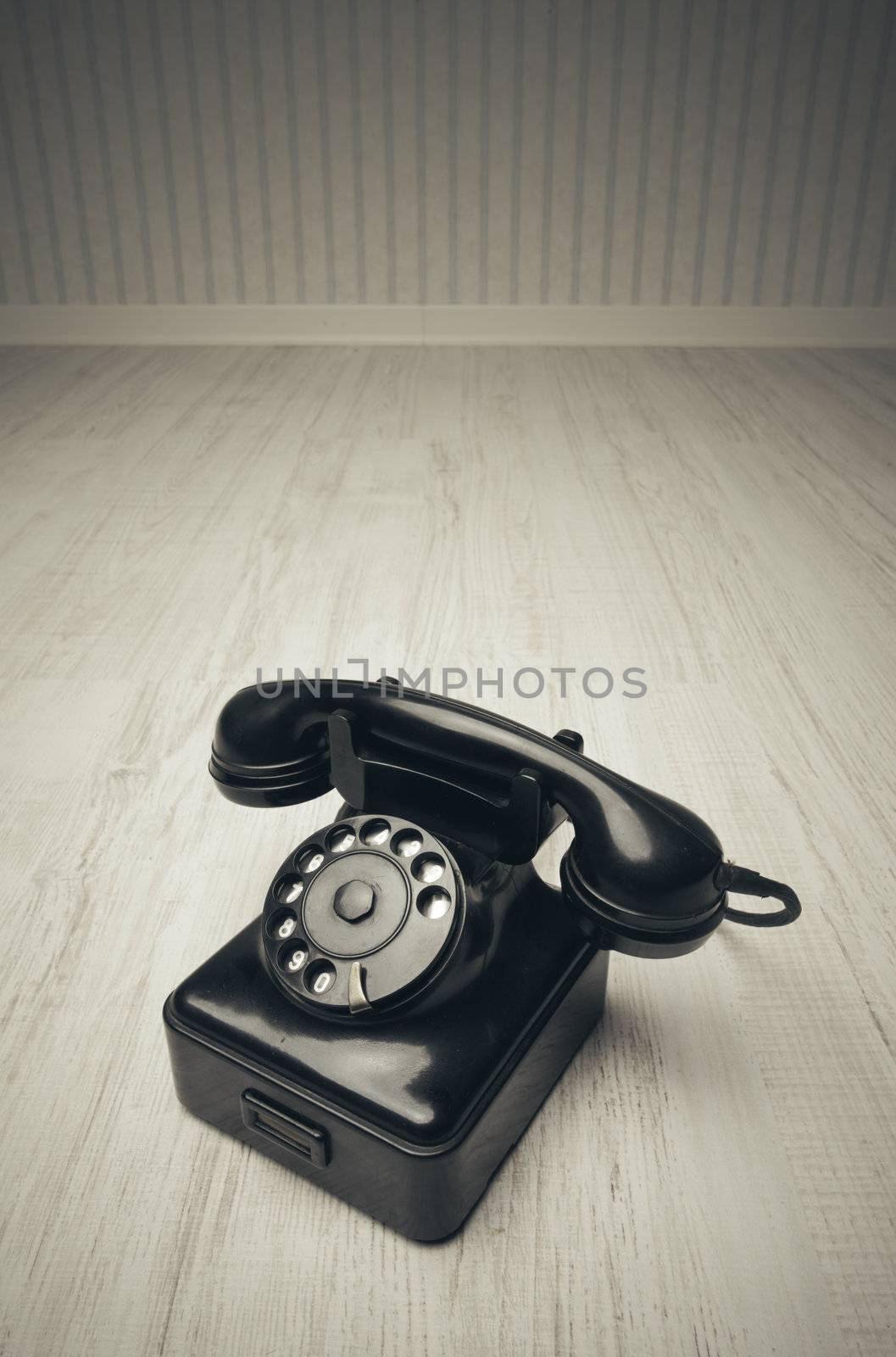 Old-fashioned phone on a wooden floor