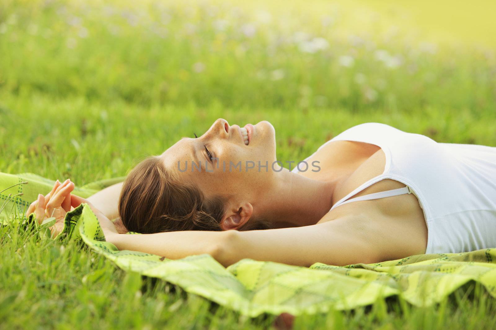 Beautiful woman laying on the grass 