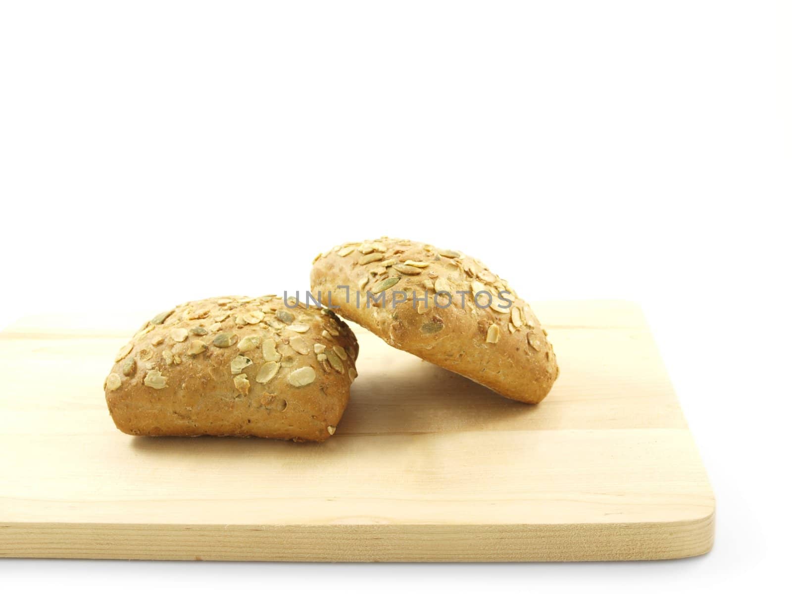 Bread with seeds isolated on a wooden board