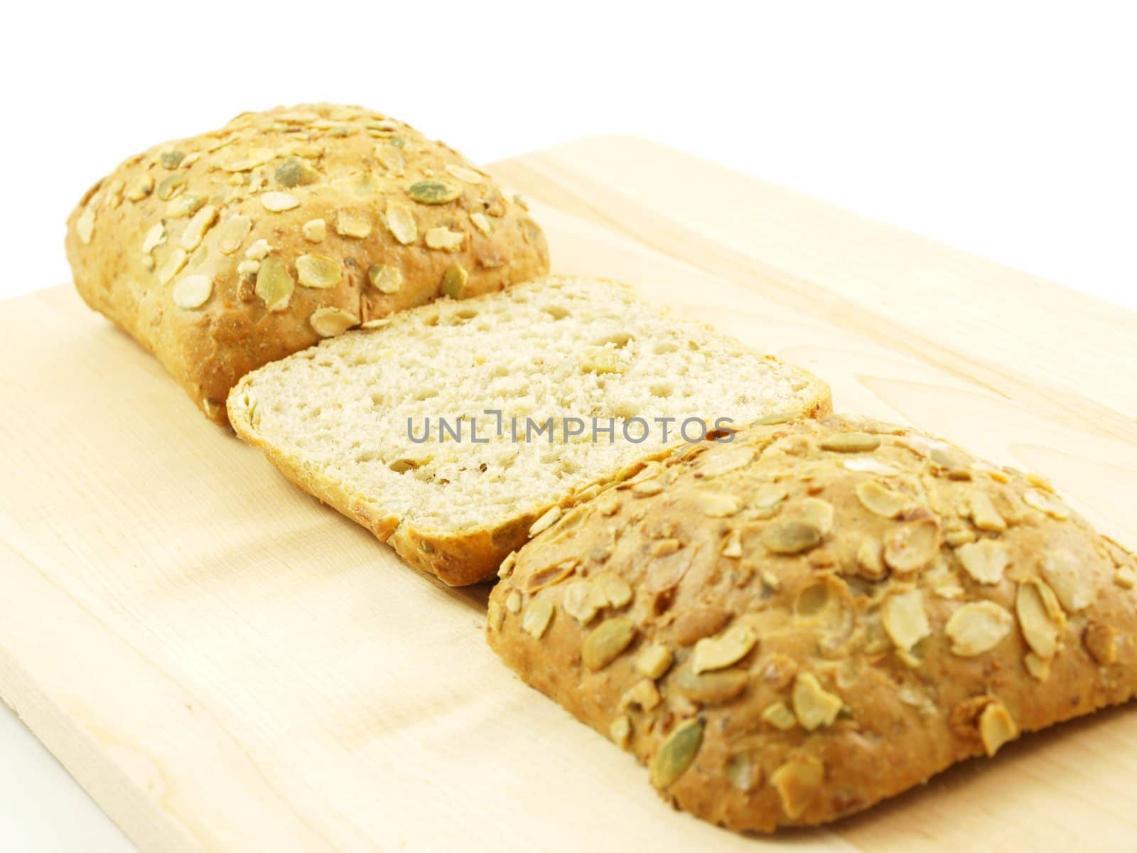 Bread with seeds isolated on a wooden board