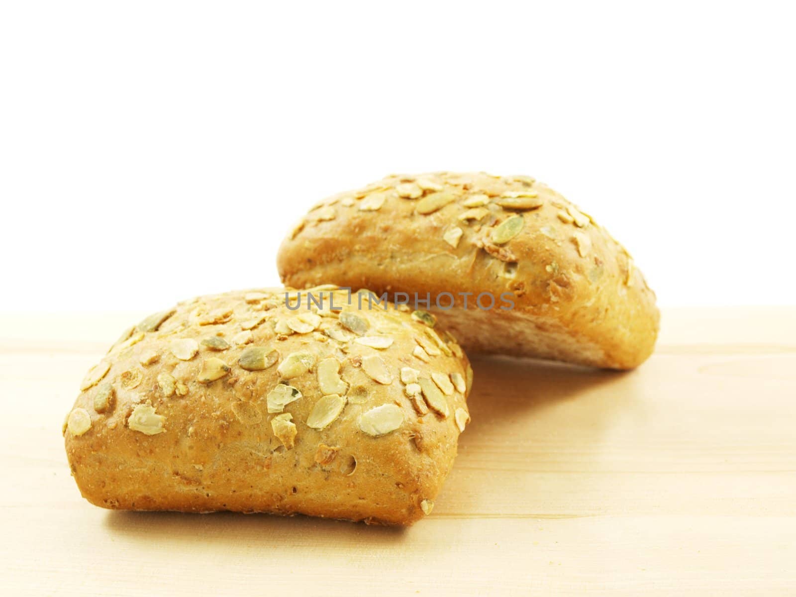 Bread with seeds isolated on a wooden board