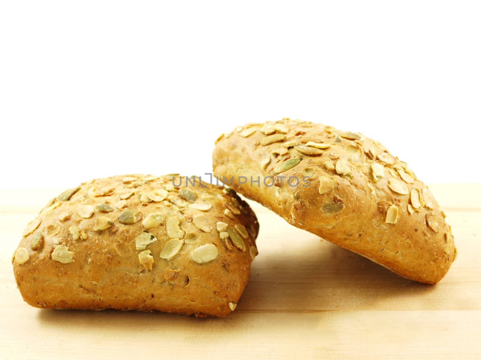 Bread with seeds isolated on a wooden board