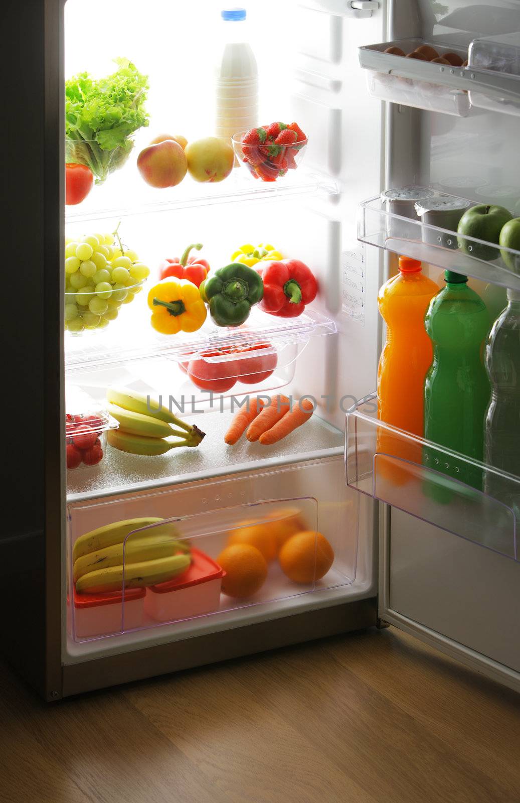 close up of a refrigerator full of fruits and vegetables