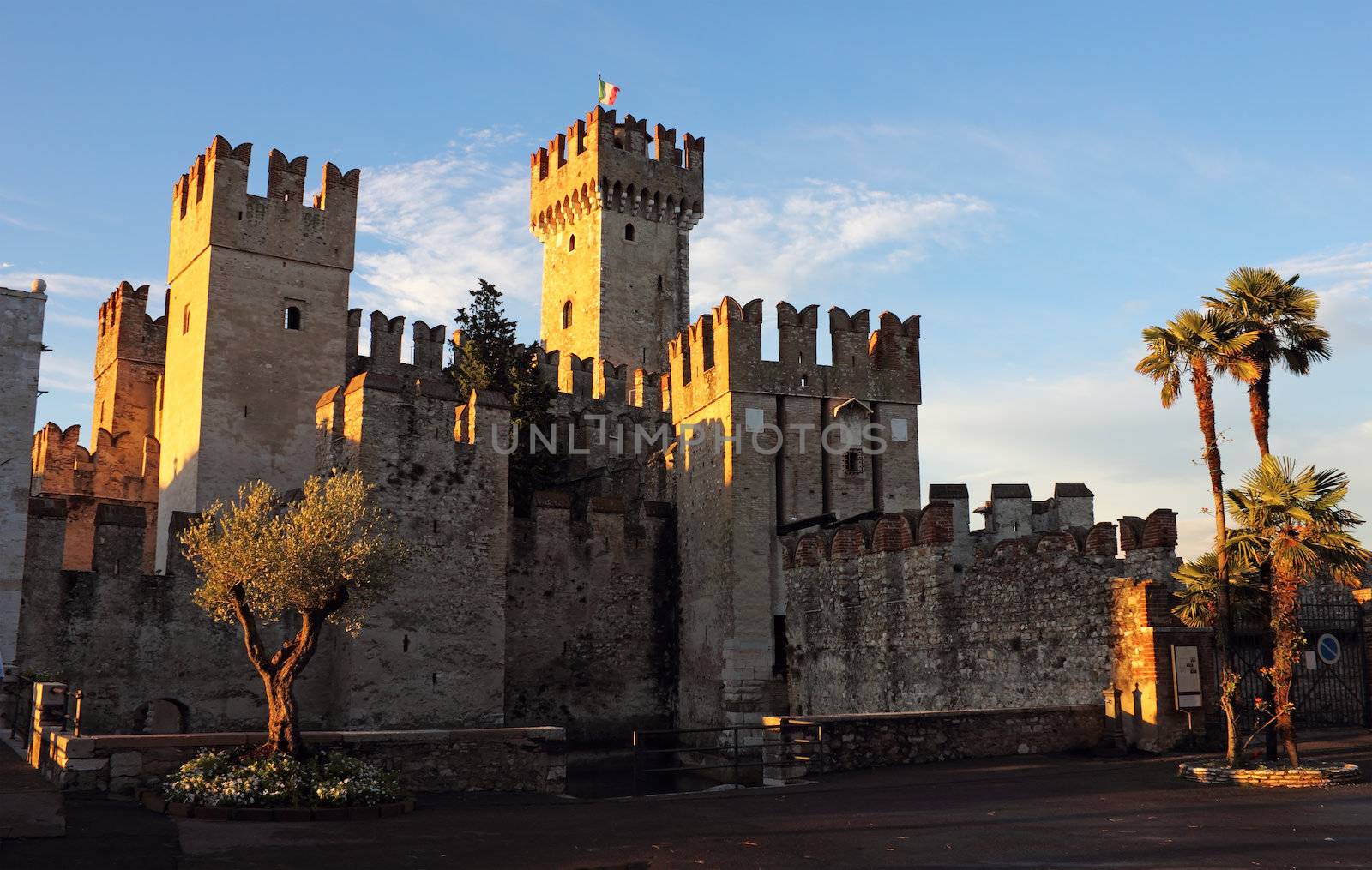 The Scaliger Castle in Sirmione, bathing in the warm sunlight of the sunset. 