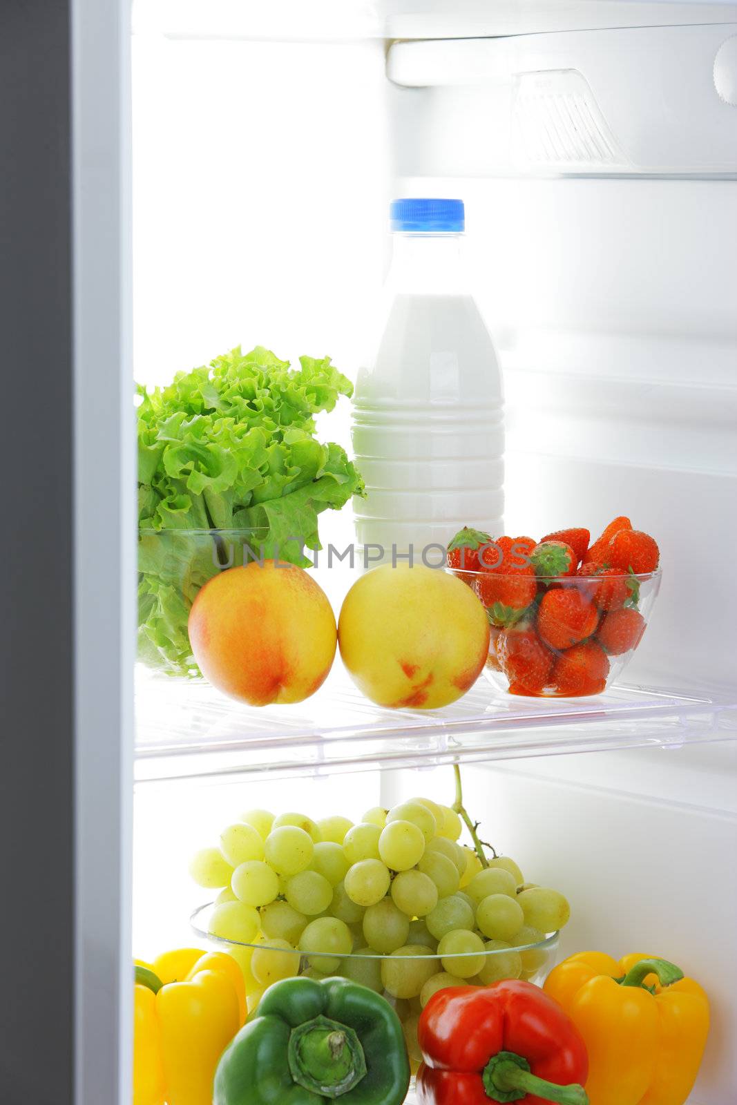 close up of a refrigerator with fruits and vegetables
