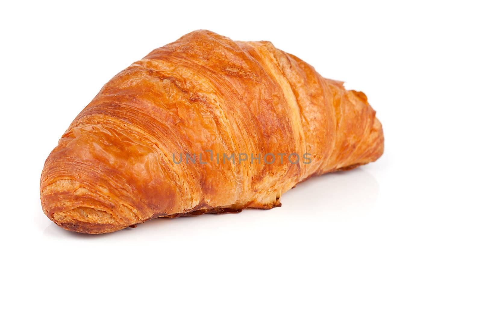 Fresh and tasty croissant over white background