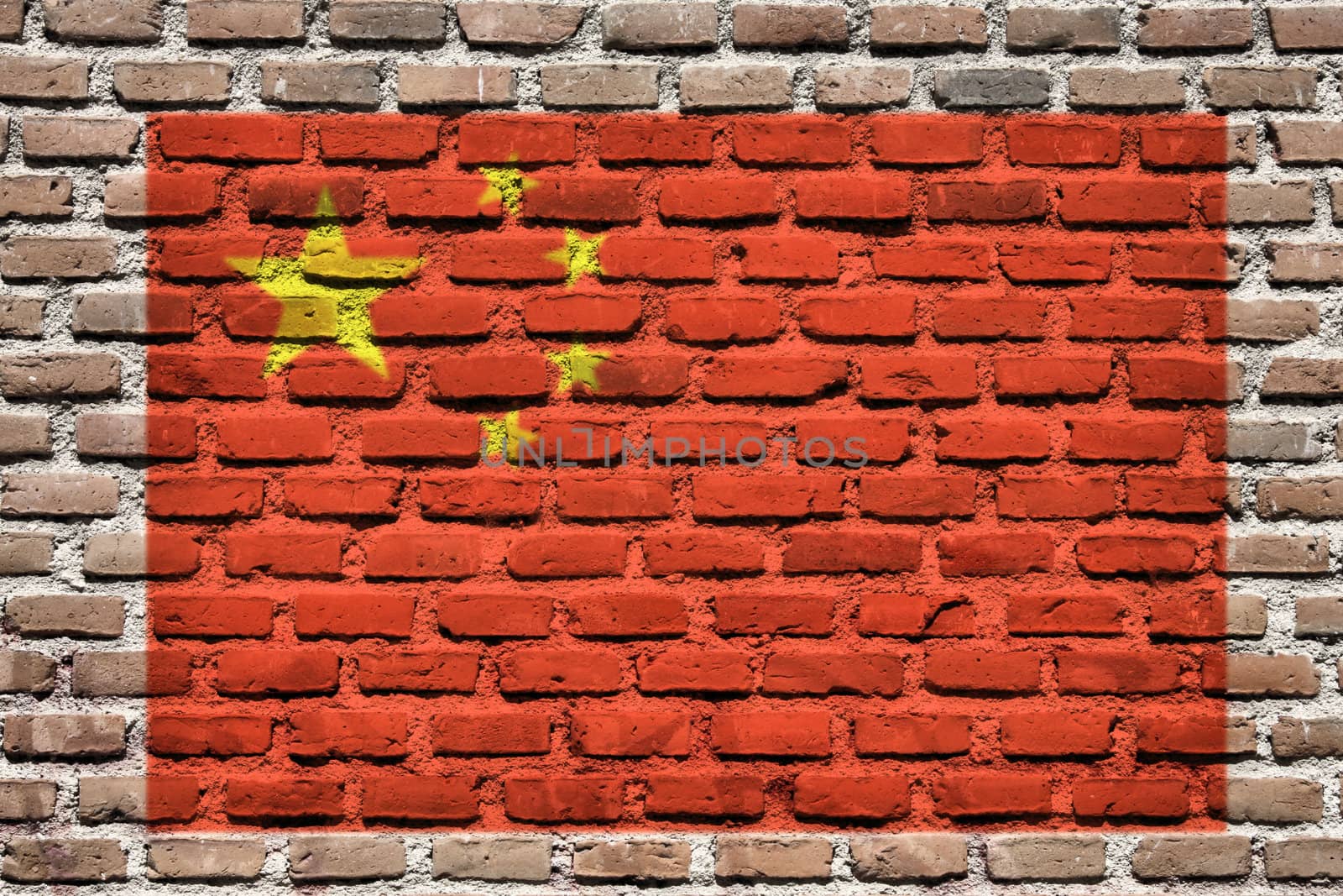 China national flag spray painted on a brick wall. Grunge graffiti.